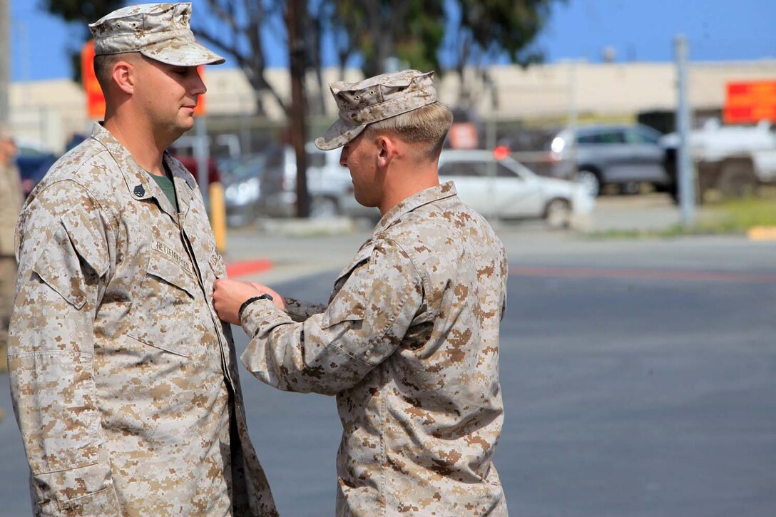 Staff Sgt. Justin M. Rettenberger, an instructor with Field Medical Training Battalion West, receives the Bronze star with the combat distinguishing "V" device, for valor at Camp Pendleton, May 23. Rettenberger was recognized for actions while deployed with 2nd Battalion, 5th Marine Regiment, in support of Operation Enduring Freedom.