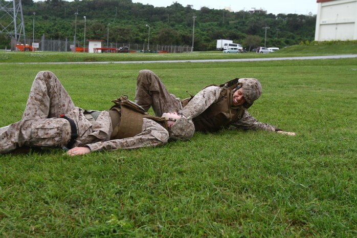 Petty Officer 3rd Class Dan B. Harlan drags Seaman Justin B. Hampton, a simulated patient, during tactical combat casualty care training May 16 at Camp Foster. Sailors from 3rd Medical Battalion participated in the training May 13-16 to ensure they are prepared to handle medical situations as a result of combat. Harlan and Hampton are hospital corpsmen with the battalion, which is a part of 3rd Marine Logistics Group, III Marine Expeditionary Force.