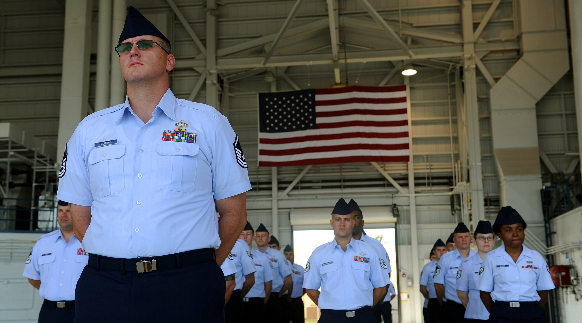 A formation of Airmen from the 15th Maintenance Operations Squadron stand at parade rest during the 15th MOS inactivation ceremony at Joint Base Pearl Harbor-Hickam, Hawaii, May 23, 2013. The unit’s roots began as the 15th Station Complement Squadron when it was constituted 70 years ago on April 5, 1943. (U.S. Air Force photo/Tech. Staff Sgt. Jerome S. Tayborn)