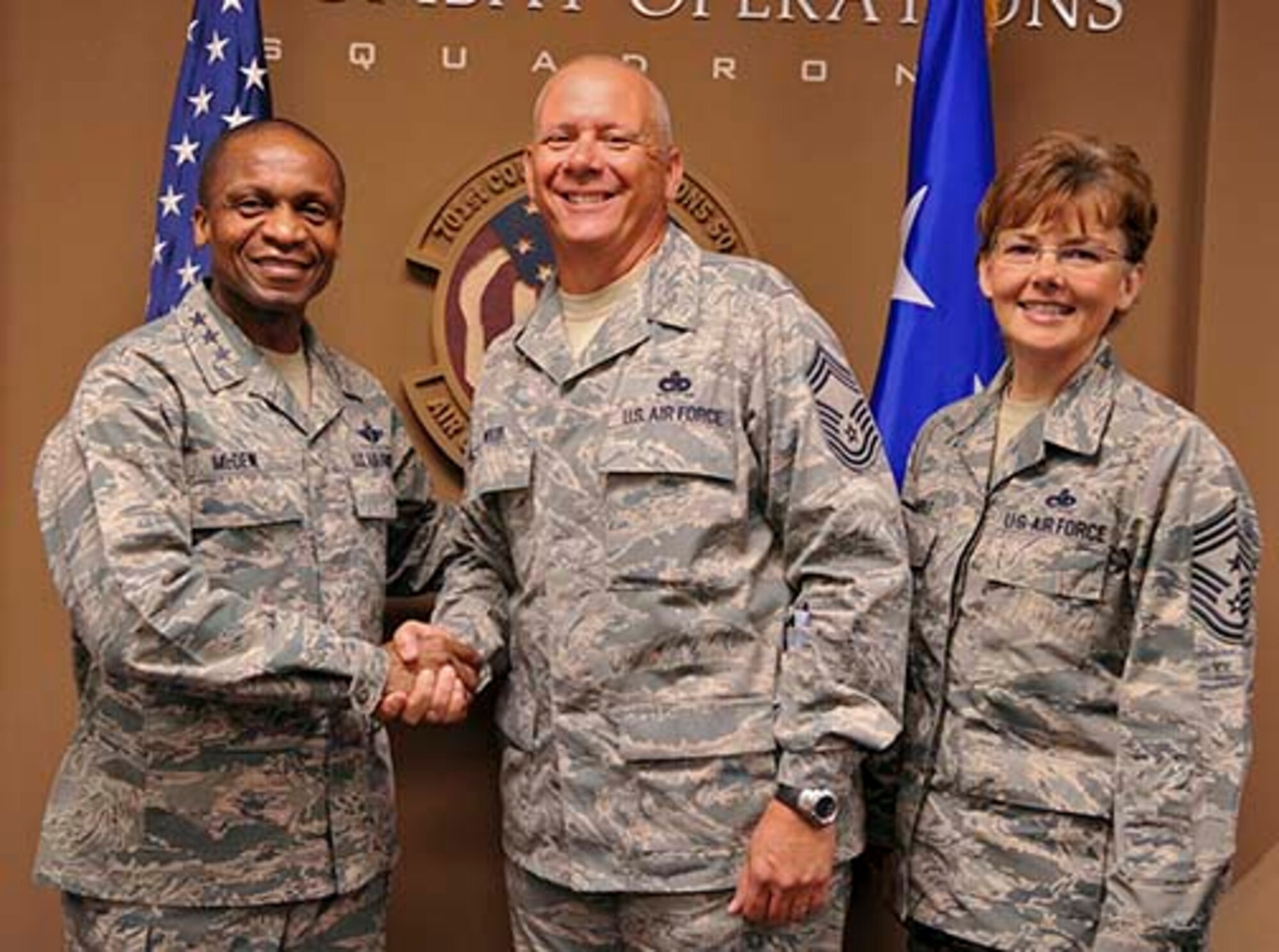 Lt. Gen. Darren McDew, commander, 18th Air Force and Chief Master Sgt. Vicki
Gamble, command chief, 18th Air Force, congratulate Chief Master Sgt. James
Wood, 56th Aerial Port Squadron, March Air Reserve Base, for Wood's
participation in Superstorm Sandy relief efforts. McDew and Gamble visited
March ARB May 8-9 to meet with Airmen face-to-face, thank them for their
service and answer their questions. Wood worked relief efforts as an Airman
and as an employee of Southern California Edison, proving that "Citizen
Airman" is more than just words. (U.S. Air Force photo/Staff Sgt. Jacquelyn Estrada)
