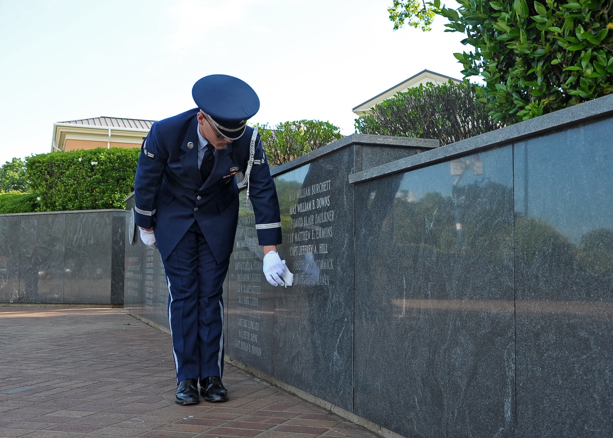 Columbus Air Force Base Honor Guard member Airman 1st Class Patrick Caffrey, 14th Force Support Squadron, reveals Capt. Jeffery A. Haney’s name on the Richard “Gene” Smith Plaza wall May 23 during a Memorial Day Retreat Ceremony.  Also revealed during the ceremony was Maj. Joseph M. McCormick of Belmont, N.C. who was among the six crew members aboard the Charlotte-based N.C. Air National Guard C-130 Hercules on July 1, 2012, when it crashed while fighting wildfires in the Black Hills region of western South Dakota.  Sixteen members of the Charlotte-based N.C. Air National Guard attended the ceremony at Columbus AFB.  (U.S. Air Force Photo/Airman 1st Class Stephanie Englar)