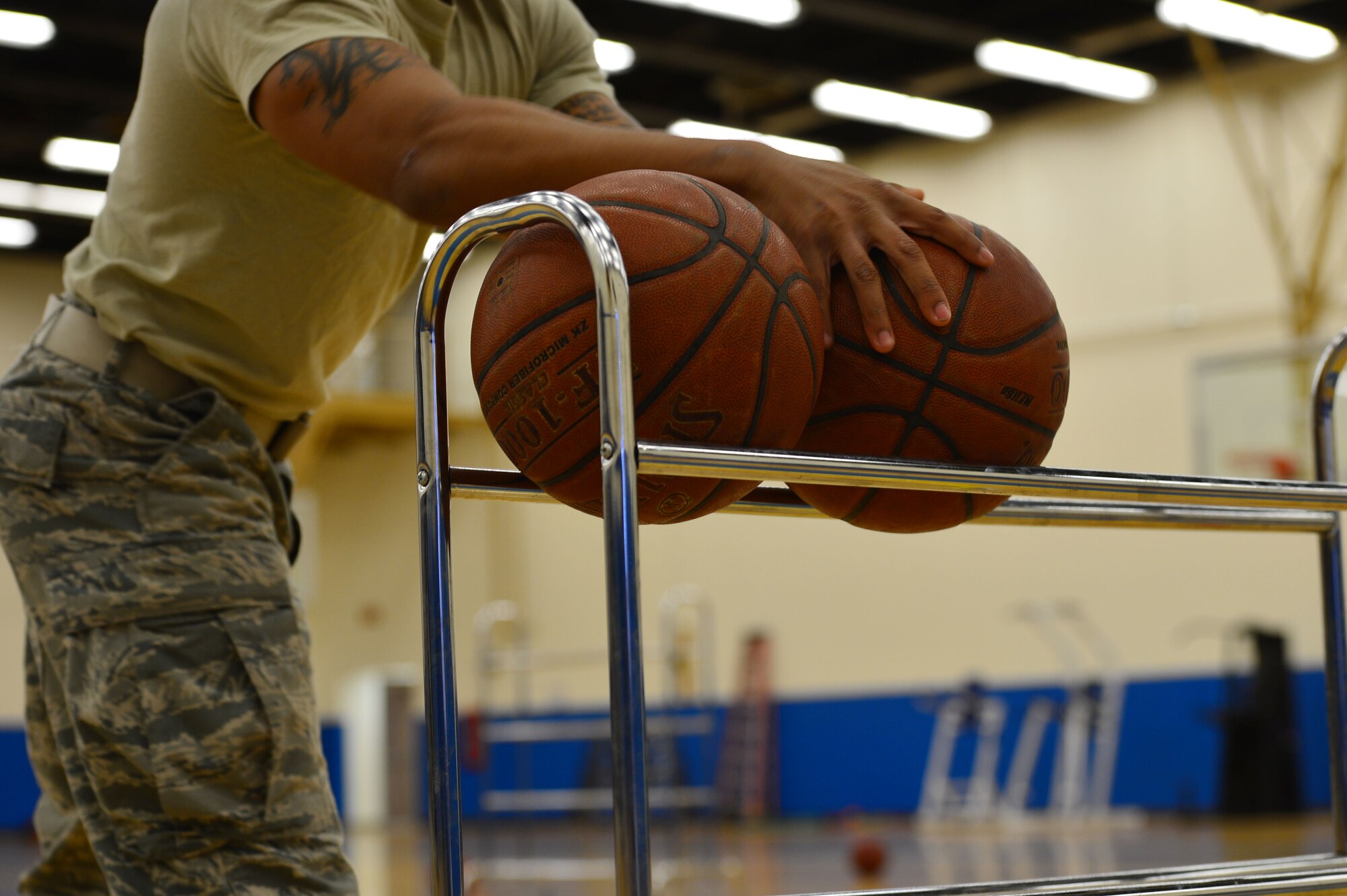 An Airman participates in a three-point shootout in the Fitness Center at Cannon Air Force Base, N.M., May 20, 2013. Several events and competitions were scheduled throughout the month of May in celebration of National Physical Fitness and Sports Month. (U.S. Air Force photo/Airman 1st Class Eboni Reece)