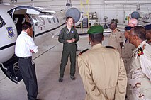 A pilot from the 458th Airlift Squadron, 1st Lt. Peter Grooms, uses his second language, French, to explain the C-21 mission to logistics officers from the Djibouti Armed Forces during a tour May 22, 2013.  The delegation visited Scott AFB, Ill, as part of an outreach program hosted by U.S. Transportation Command.  (U.S. Air Force photo/Christine Spargur)