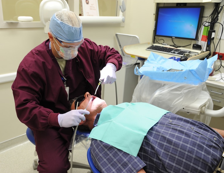 Staff Sgt. Justin Jones, 341st Medical Operations Squadron dental technician, performs a dental exam on Mike Mehegan, Montana Military Retirees Council member, at the clinic on May 18. This is the fourth year Jones has volunteered at the annual event. (U.S. Air Force photo/Airman 1st Class Katrina Heikkinen)