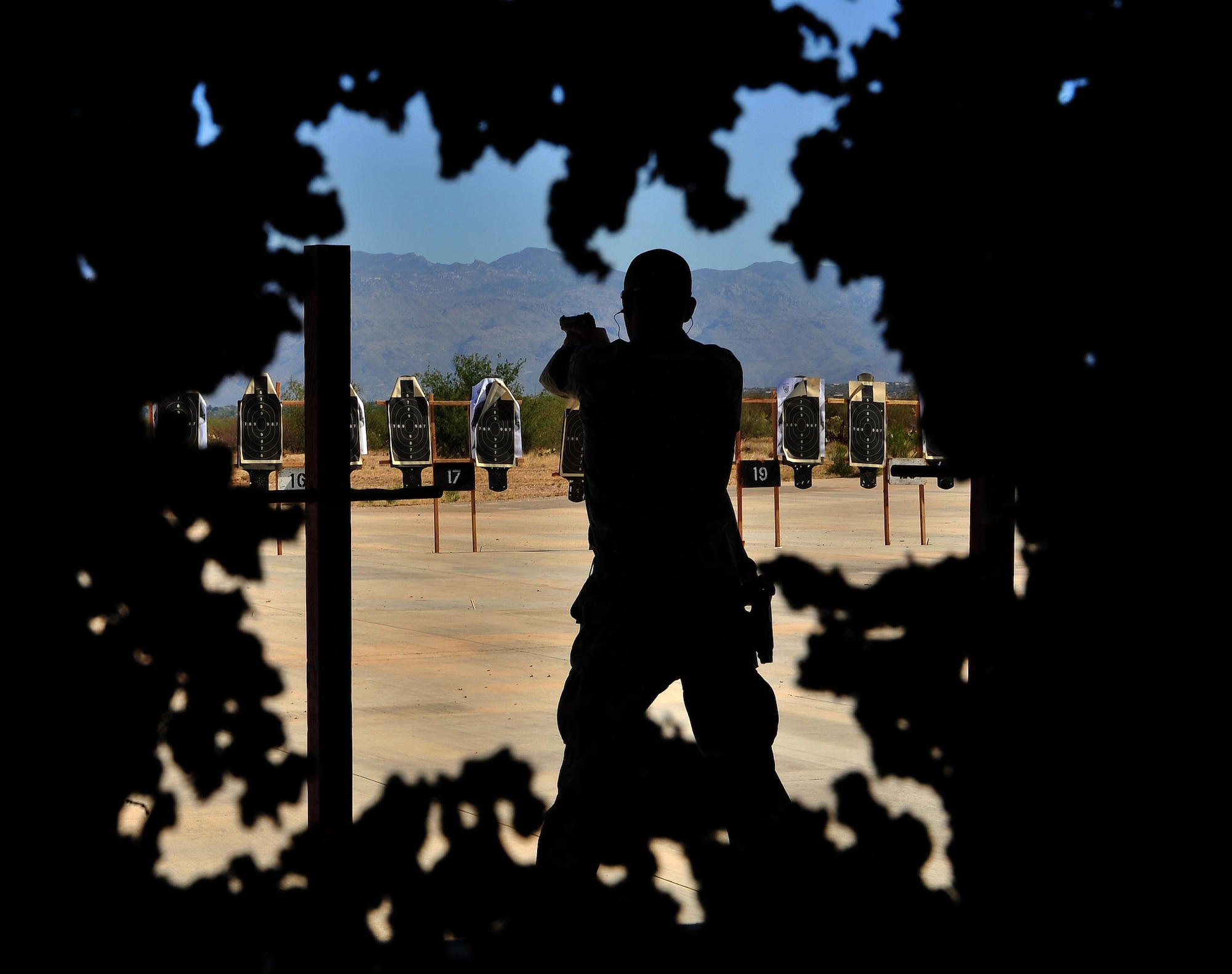 A contestants fires off rounds during the shooting competion at Davis-Monthan Air Force Base, Ariz., May 17, 2013. The competion is part of national Police Week.(U.S. Air Force Photo by Airman 1st Class Josh Slavin)