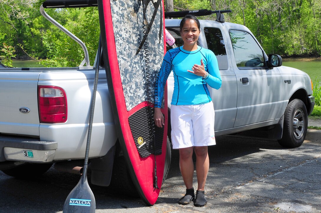 Maj. Elisa Hammer, 779th Aeromedical Squadron Bioenvironmental Engineering Flight chief, stands with her paddleboard gear prior to hitting the water, May 3, 2013, in Arlington, Va. Bioenvironmental engineer and Airman during the week, water-bound on the weekends, Hammer pulls her way of life and leadership style from generations of hard-working family members in Hawaii. (U.S. Air Force photo by Senior Airman Steele C. G. Britton)