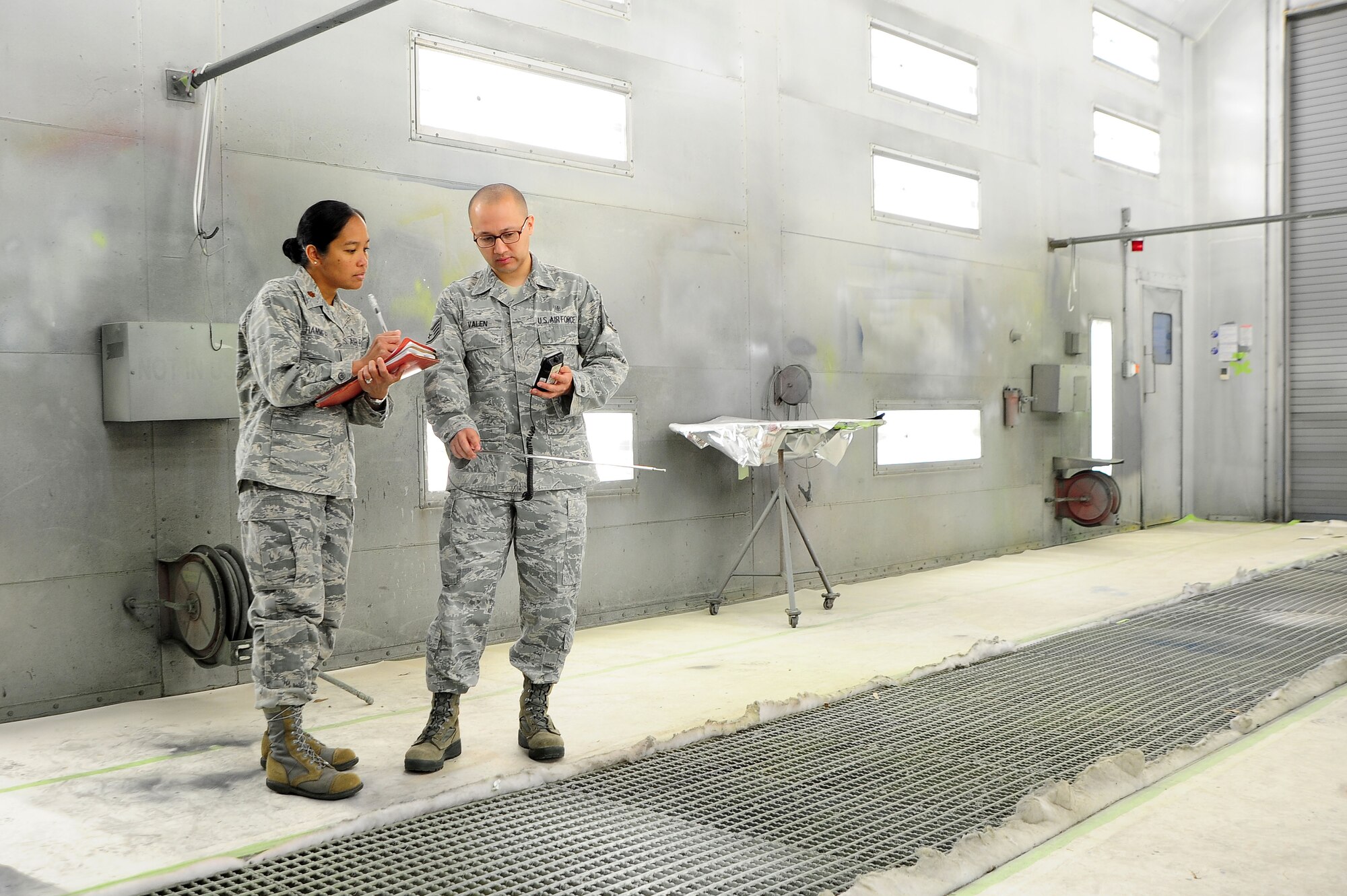 Maj. Elisa Hammer, 779th Aeromedical Squadron Bioenvironmental Engineering Flight chief, and Staff Sgt. Emanuel Valen, 779th AMDS bioenvironmental engineering technician, test air ventilation in an aircraft paint booth, May 2, 2013, at Joint Base Andrews, Md. Outside of the industrial workplace, the bioenvironmental Airmen also ensure safe drinking water to the base community. (U.S. Air Force photo by Senior Airman Steele C. G. Britton)