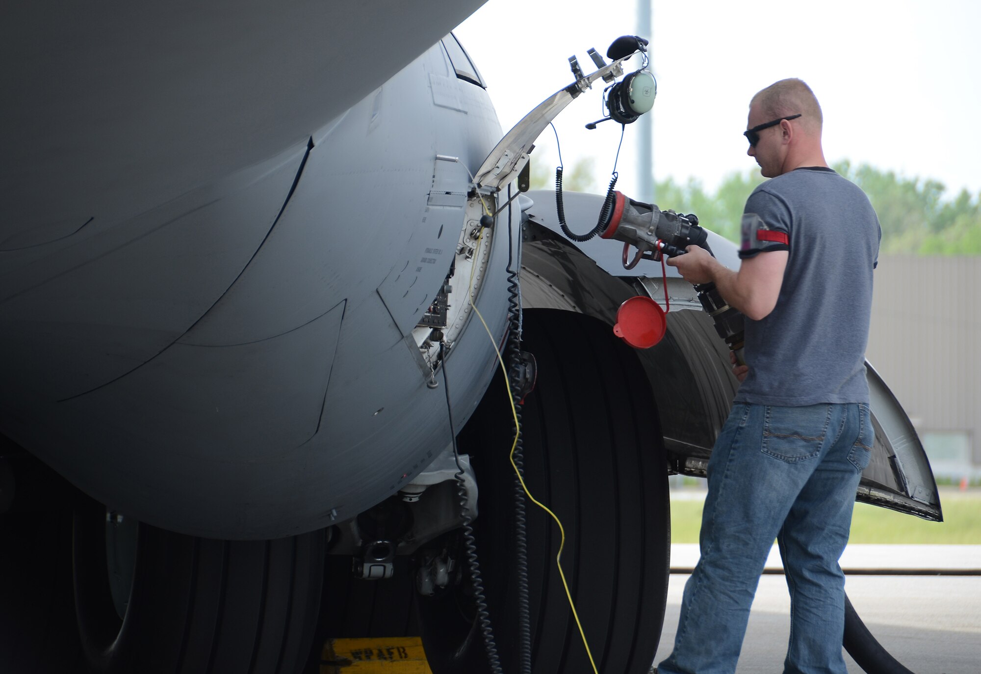 WRIGHT-PATTERSON AIR FORCE BASE, Ohio – Tech. Sgt. Scott Bunch, 445th Aircraft Maintenance Squadron, aircraft mechanic, refuels a 445th Airlift Wing C-17 Globemaster III May 21. (U.S. Air Force photo/Staff Sgt. Mikhail Berlin)