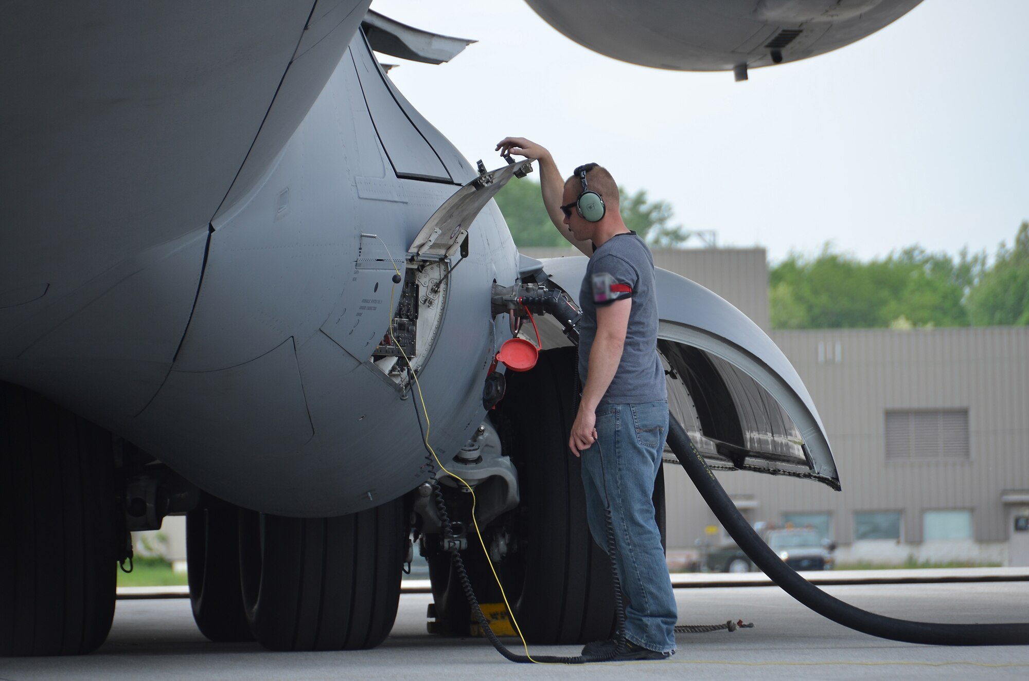 WRIGHT-PATTERSON AIR FORCE BASE, Ohio – Tech. Sgt. Scott Bunch, 445th Aircraft Maintenance Squadron, aircraft mechanic, refuels a 445th Airlift Wing C-17 Globemaster III May 21. (U.S. Air Force photo/Staff Sgt. Mikhail Berlin)