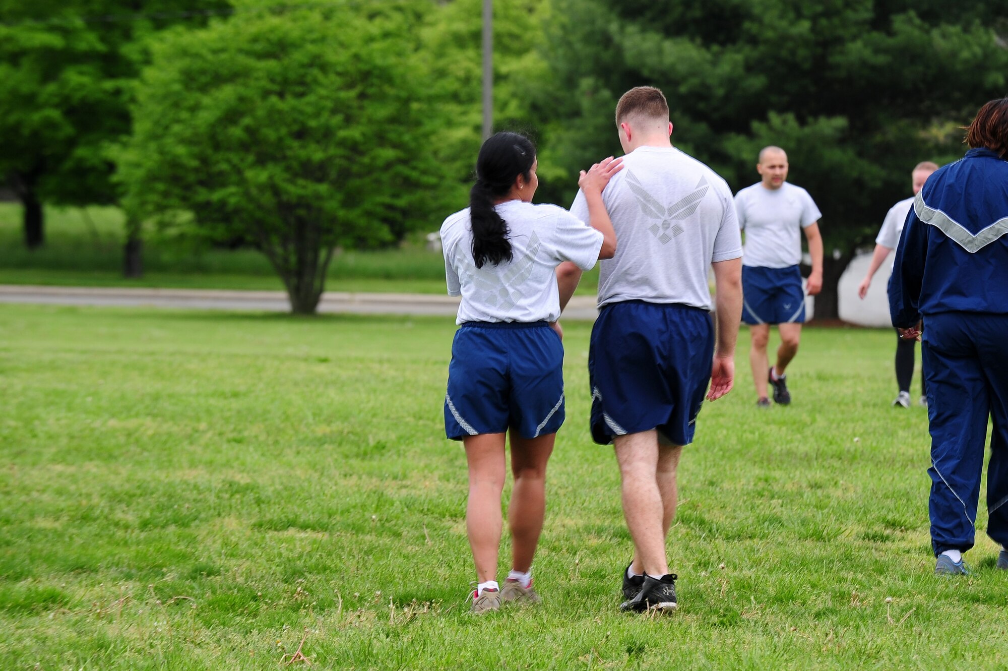 Maj. Elisa Hammer, 779th Aeromedical Squadron Bioenvironmental Engineering Flight chief, congratulates a fellow Airman following a touchdown during a friendly game of two-hand-touch football, May 2, 2013, at Joint Base Andrews, Md. ?We all come from different parts of this country and we are each other?s family,? said Hammer. ?I like our flight to feel that sense of cohesion and teamwork.? (U.S. Air Force photo by Senior Airman Steele C. G. Britton)