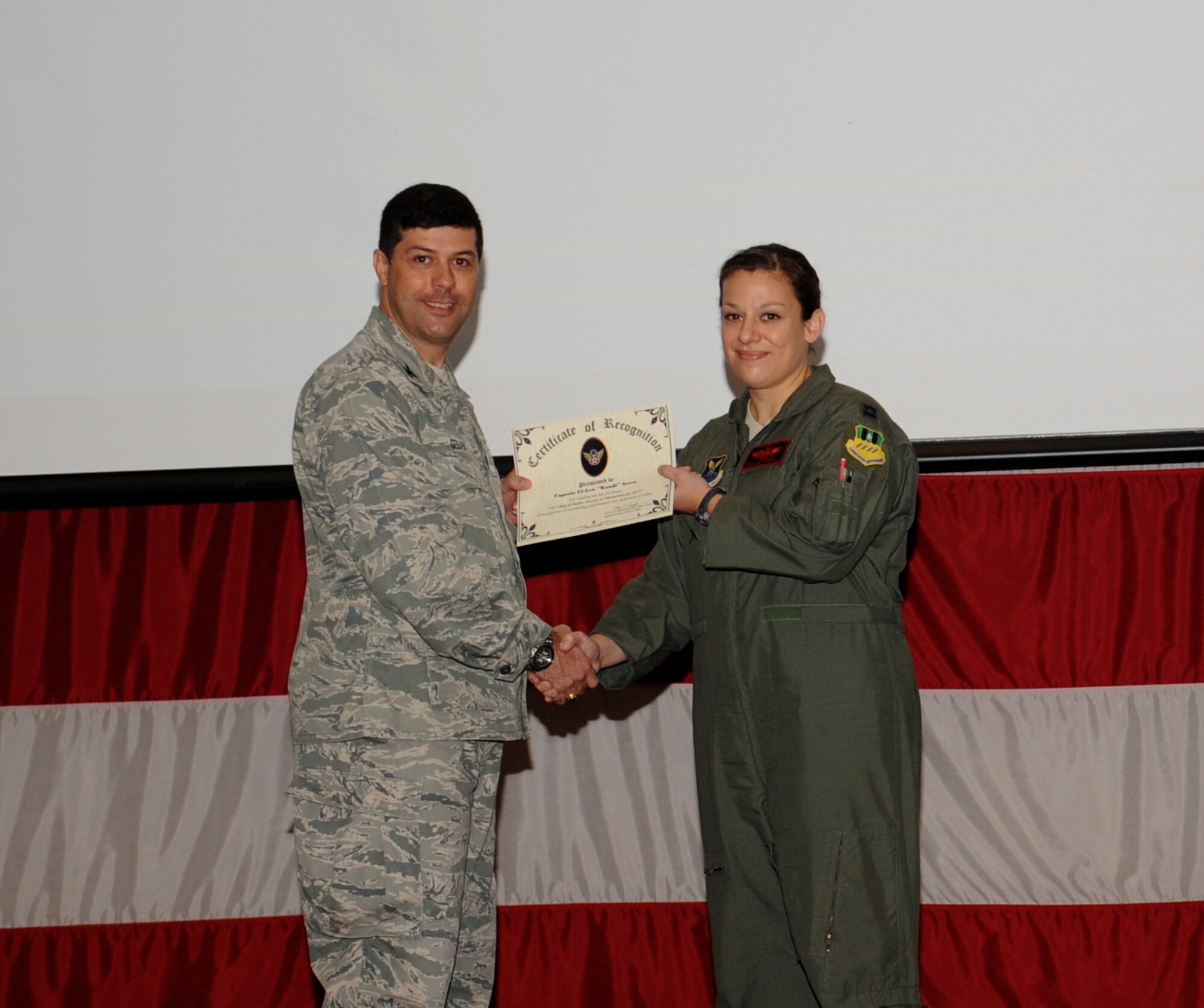 Capt. El-Len Serra, 96th Bomb Squadron pilot, receives the Air Force Chief of Safety Aircrew of Distinction award for Air Force Global Strike Command from Col. Andrew Gebara, 2nd Bomb Wing commander, on Barksdale Air Force Base, La., May 23, 2013. Serra and her crew were recognized for their actions during an air refueling emergency. (U.S. Air Force photo/Airman 1st Class Benjamin Gonsier)