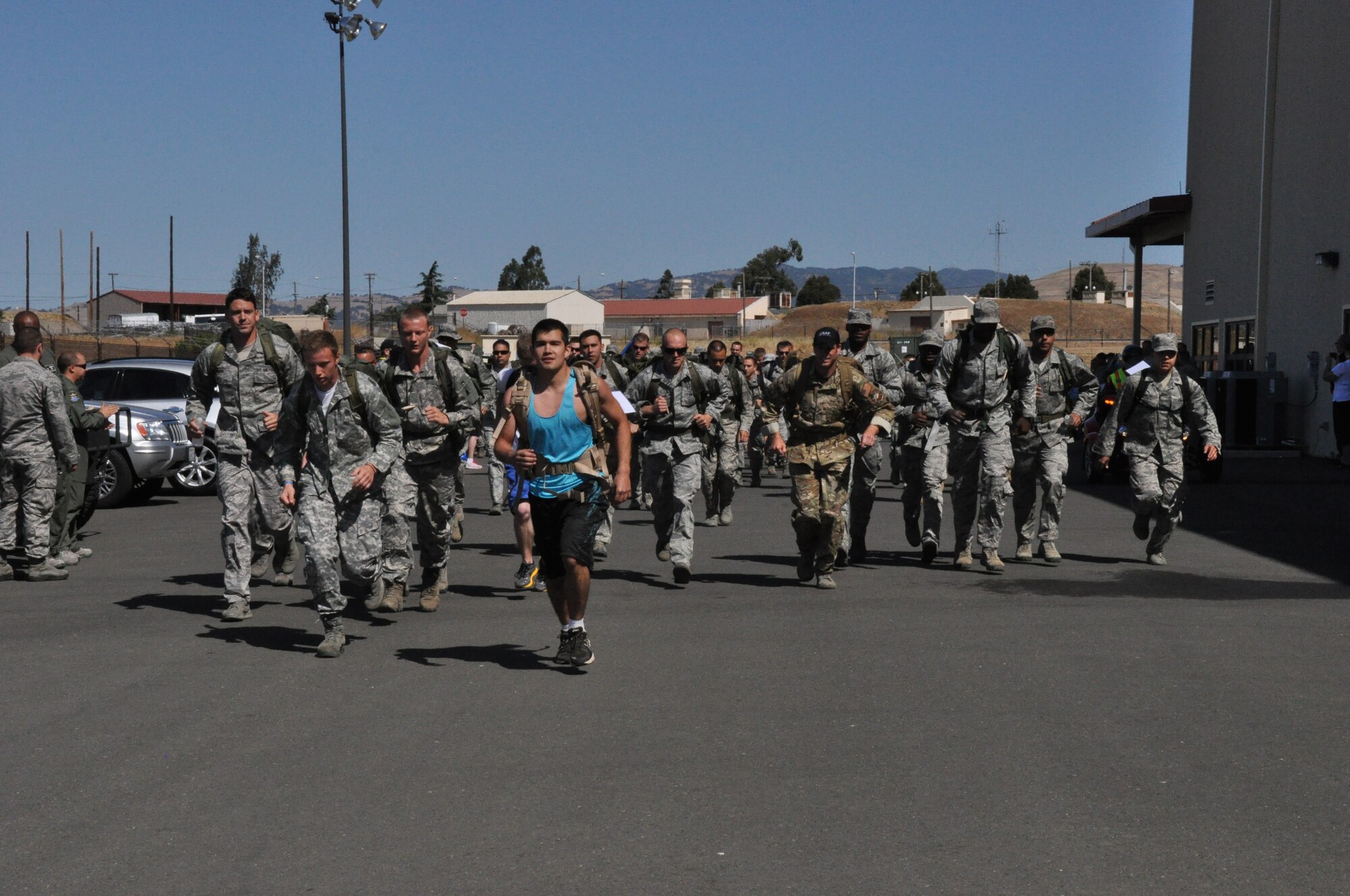 Hundreds of Airmen and their families banded together to participate in the third Annual Gold Star Family Ruck March in honor of fallen servicemembers and their families here at Travis Air Force Base, Calif. on May 18, 2013. 
   The purpose of the event was to bring awareness to the base and its community about Gold Star Moms and their families. Although fallen servicemembers are the ones who ultimately pay the price with their lives for our nation, their families are left behind with holes in their hearts. The Gold Star Moms program brings families together to gain strength from one another in a time when they are suffering most.
   "This event is for a great cause," said Senior Airman John Krueger, 22nd Airlift Squadron. “This is for so much more and I’ll definitely be back out here next year,” he said.
   “I wanted to honor all the families who have lost a loved one,” said Staff Sgt. Steven Kreidler 60th Medical Operations Squadron. “It’s a good way to keep them alive. It felt good,” he added.
   The participants walked or ran the 10k (6.2 miles) long a course that winded through Travis AFB. There were three different divisions to participate in: military heavy, which consisted of the ABU uniform and a 30 pound backpack; military light, which included members in uniform without the backpack; and a civilian division. Participants could walk, run, or even crawl during the event. Some participants competed alone, while others joined forces and competed in a four-man team.  
   Senior Airman Tyler Saulsgiver, 60th Civil Engineering Squadron, participated in one of the four-man teams. “It was tough,” he said. “We trained every Friday for two months. It was an experience for sure.”
   Maj. Daniel Craig, 60th CES, ran alongside his wife, a civilian, and their baby in a jogging stroller. “This was my wife’s first 10k and what better way to do it than do it for the Gold Star Moms,” he said.
   Each participant was fitted with a laminated sheet of paper that include