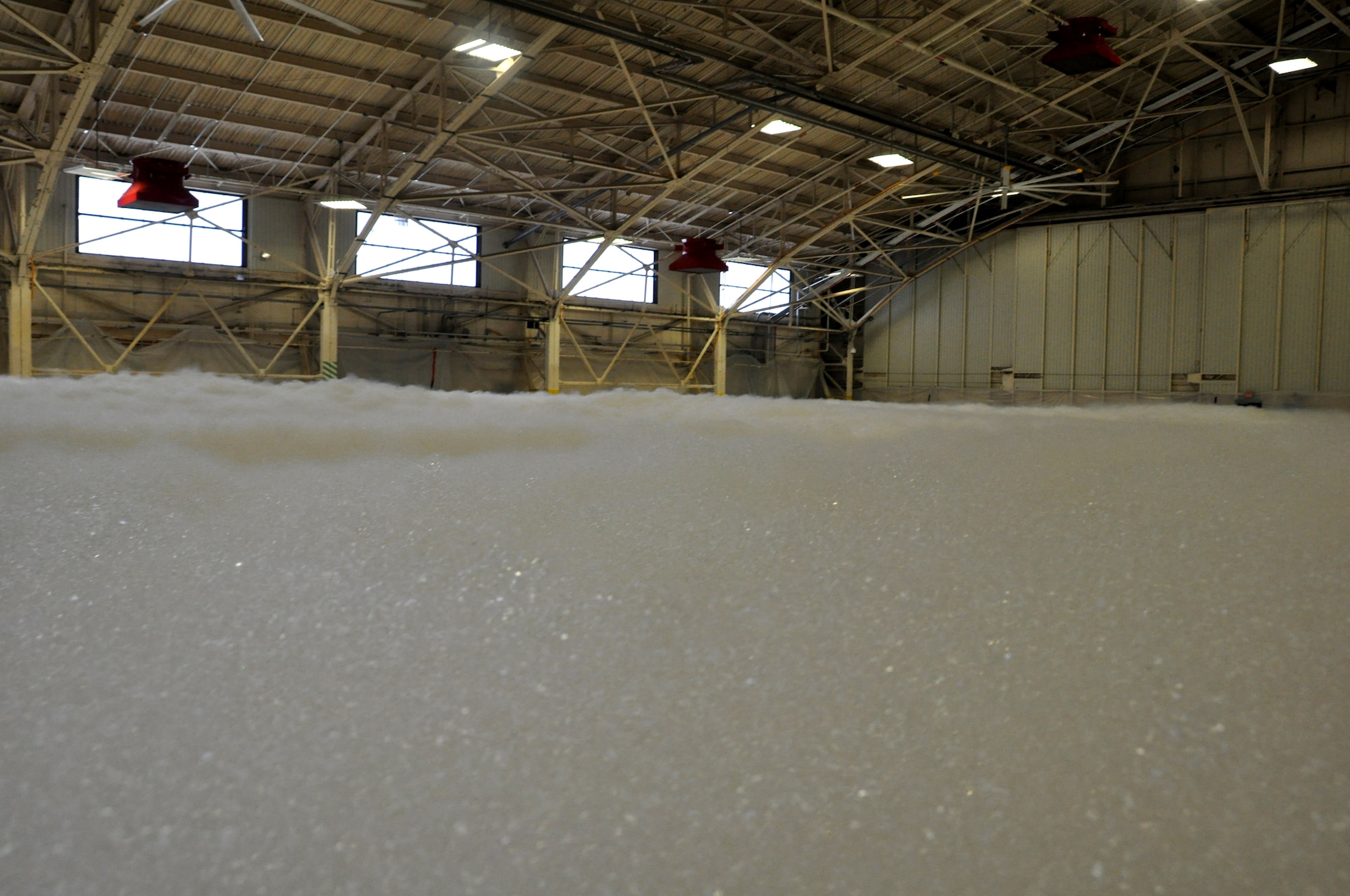 The 325th Civil Engineer Squadron tested the high expansion foam fire supression system in Hangar 2 as part of the final steps in the renovation process May 22. Six feet of expanded foam filled the 26,000 square foot hangar bay in less than two minutes.(U.S. Air Force photo by 2nd Lt. Andrea Valencia)