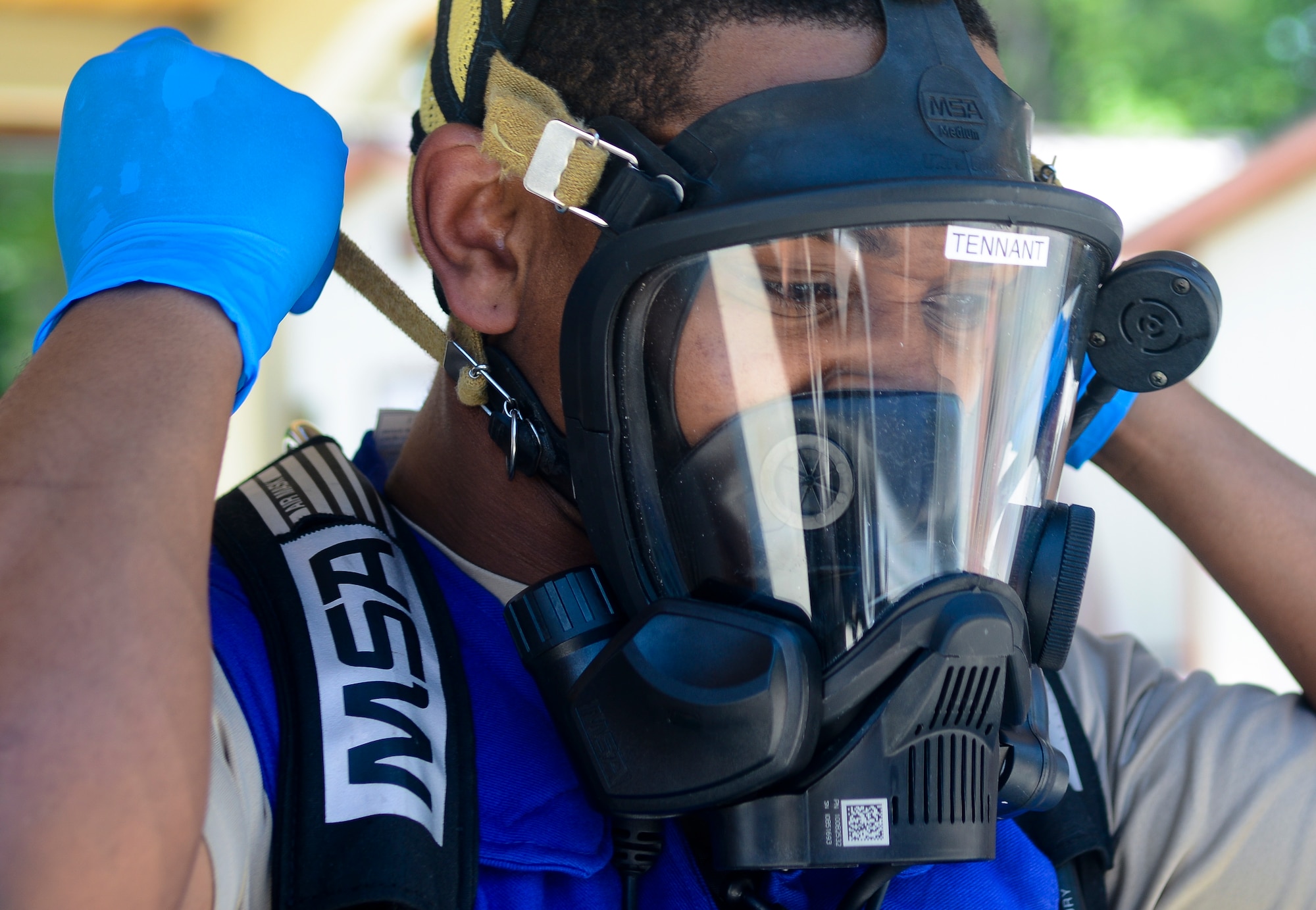 U.S. Air Force Senior Airman Ronell Tennant, 633rd Civil Engineer Squadron emergency management technician, tightens his breathing apparatus during a training exercise at Langley Air Force Base, Va., May 16, 2013. The training included personnel from the 633rd Medical Group’s bioenvironmental division and the 633rd CES’s fire and emergency services. (U.S. Air Force photo by Airman 1st Class Austin Harvill/Released)