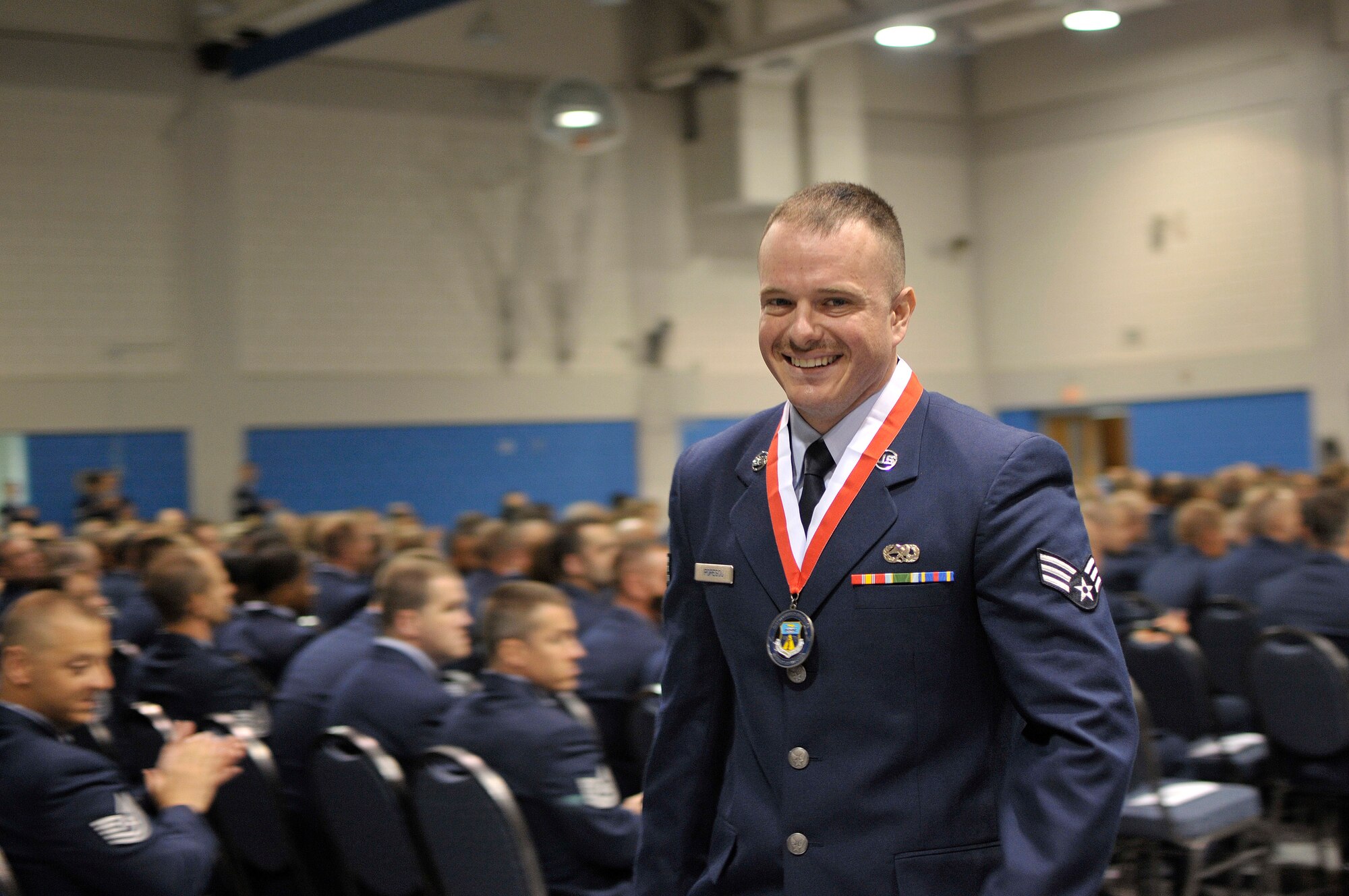 MCGHEE TYSON AIR NATIONAL GUARD BASE, Tenn. – U.S. Air National Guard Senior Airman Victor Popescu, from Ohio, is called to the stage for earning the Academic Achievement Award for Airman Leadership School. Popescu graduated with others from his ALS class as well as Noncommissioned Officer Academy graduates May 23, 2013, from the Paul H. Lankford Enlisted Professional Military Education Center. Their ceremony featured guest speaker Chief Master Sgt. Richard A. "Andy" Kaiser, command chief of U.S. Air Force Air Mobility Command. (U.S. Air National Guard photo by Master Sgt. Mike R. Smith/Released)