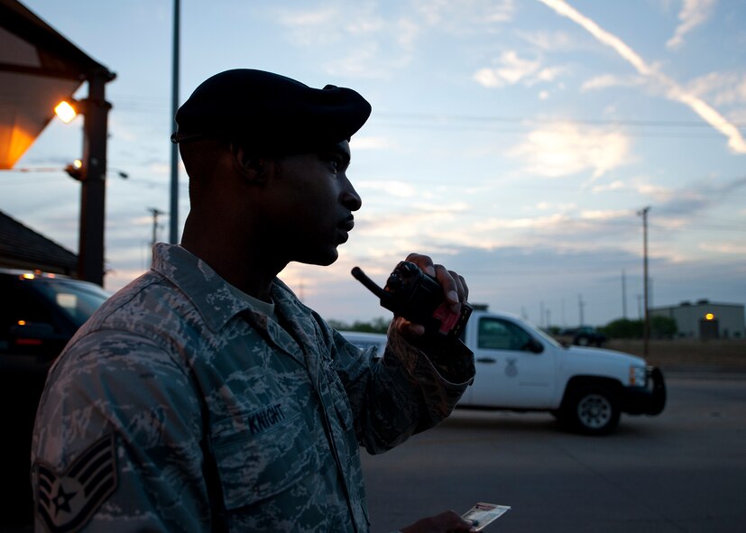 U.S. Air Force Staff Sgt. Antinain Knight, 7th Security Forces Squadron (SFS), contacts the emergency communications center to ensure personnel have the correct credentials to enter the base May 9, 2013, at Dyess Air Force Base, Texas. More than 4,000 vehicles pass through the gates of Dyess on any given day. The 7th SFS is in charge of ensuring personnel entering the base have the correct credentials and vehicles are secure. They’re also entrusted with protecting people, property and resources at Dyess. (U.S. Air Force photo by Airman 1st Class Damon Kasberg/Released)