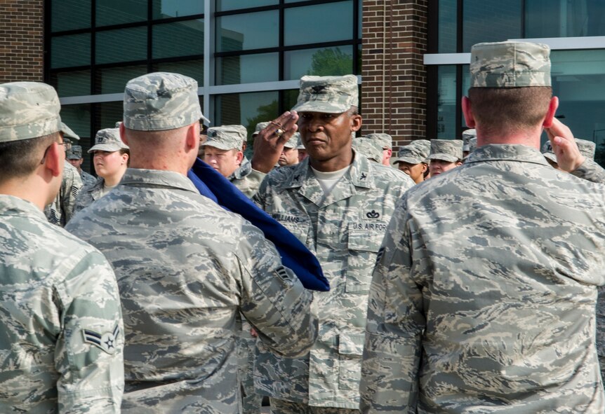Col. Calvin Williams, Air Force District of Washington director of logistics, installations and mission support, salutes AFDW Airmen during HQ AFDW’s first retreat ceremony at the Jones Building May 16, 2013 on Joint Base Andrews, Md. AFDW is responsible to organize, train, equip and provide forces for air and expeditionary force deployment, provide ceremonial support, and conduct homeland operations as part of a Joint effort, within the National Capital Region. (U.S. Air Force photo by Senior Airman Tabitha N. Haynes) 