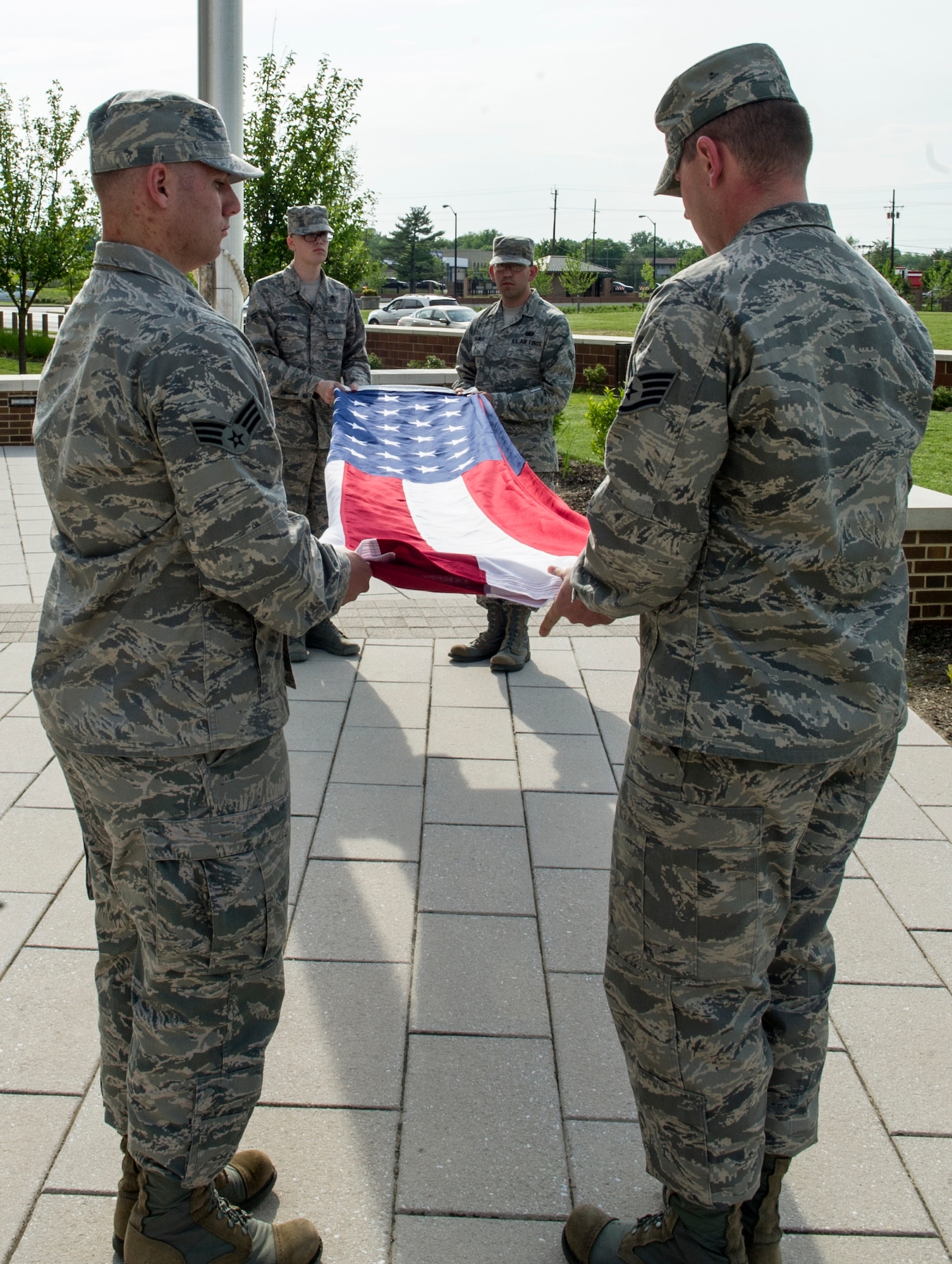 Headquarters Air Force District of Washington Airmen fold the flag during HQ AFDW’s first retreat ceremony at the Jones Building May 16, 2013 on Joint Base Andrews, Md. The "Retreat" ceremony is meant to signal the end of the official duty day. The ceremony, steeped in history, is a time for all to stop and show respect. (U.S. Air Force photo by Senior Airman Tabitha N. Haynes)