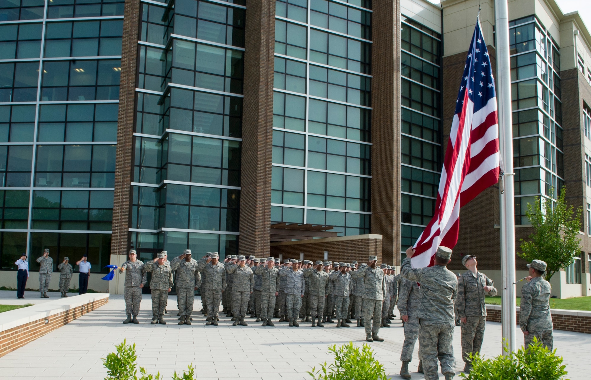 Headquarters Air Force District of Washington Airmen let down the flag during HQ AFDW’s first retreat ceremony at the Jones Building May 16, 2013 on Joint Base Andrews, Md. The "Retreat" ceremony is meant to signal the end of the official duty day. The ceremony, steeped in history, is a time for all to stop and show respect. (U.S. Air Force photo by Senior Airman Tabitha N. Haynes) 
