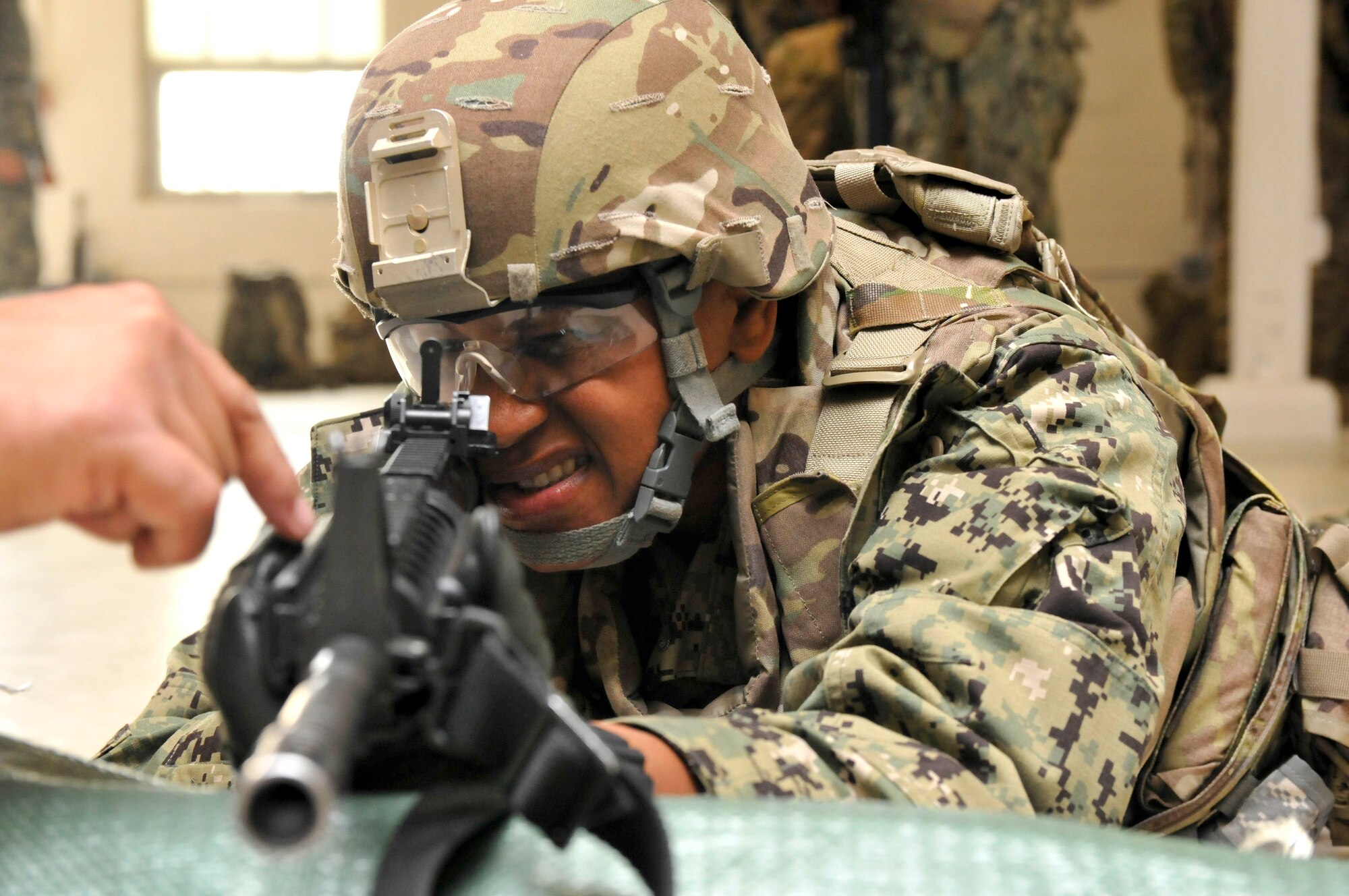 U.S. Navy Petty Officer 1st Class Denise N. Peele practices sighting a target during a preliminary marksmanship instruction course May 15, 2013, at Joint Base McGuire-Dix-Lakehurst, N.J. Marksmanship training is a requirement before service members deploy to Afghanistan. (U.S. Army photo by Sgt. Cody Stagner/Released)