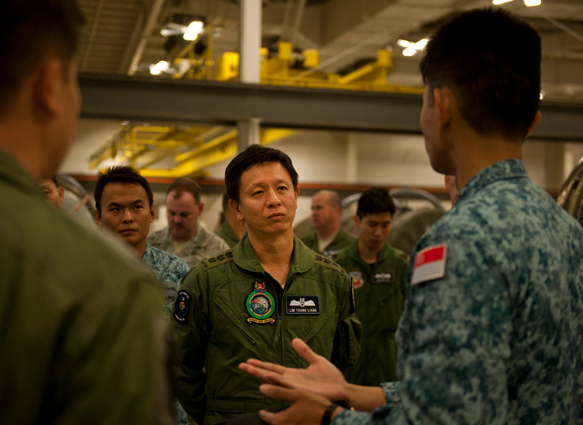 Republic of Singapore’s Air Combat Command Commander Col. Lim Tuang Liang listens as an RSAF Airman explains their duties in the engine shop May 16, 2013 at Mountain Home Air Force Base, Idaho. The RSAF shares the engine shop with the U.S. Air Force. (U.S. Air Force Senior Airman Heather Hayward/Released)