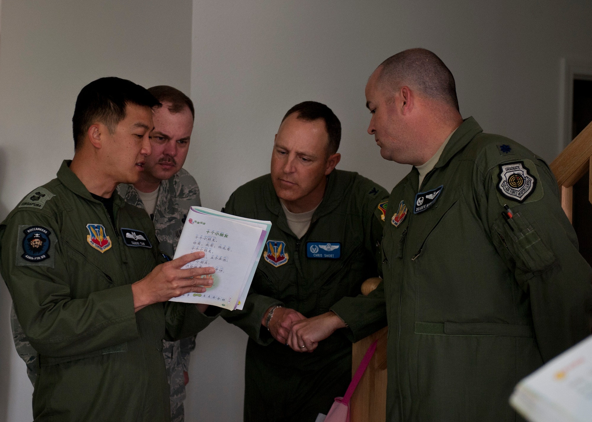 A Republic of Singapore Air Force lietenant colonel explains a book written in Chinese to U.S. Air Force members May 16, 2013 at Mountain Home Air Force Base, Idaho. As opposed to American textbooks which are generally vaults of straight-up information, Singaporean books present information in the context of stories. (U.S. Air Force photo by Senior Airman Heather Hayward/Released)