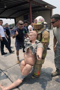 A firefighter competes in a timed obstacle course, designed to simulate the physical exertion a firefighter would experience in a hour long firefighting operation during a four day Central American Sharing Mutual Operational Knowledge and Experiences exercise, May 6-9. The four-day training exercise CENTAM SMOKE involved firefighters from Guatemala, Panama, Honduras, Nicaragua and El Salvador, allowed the firefighters a chance to train together and help build the partnerships with Joint Task Force-Bravo and the Central American countries. (DoD photo by Martin Chahin)