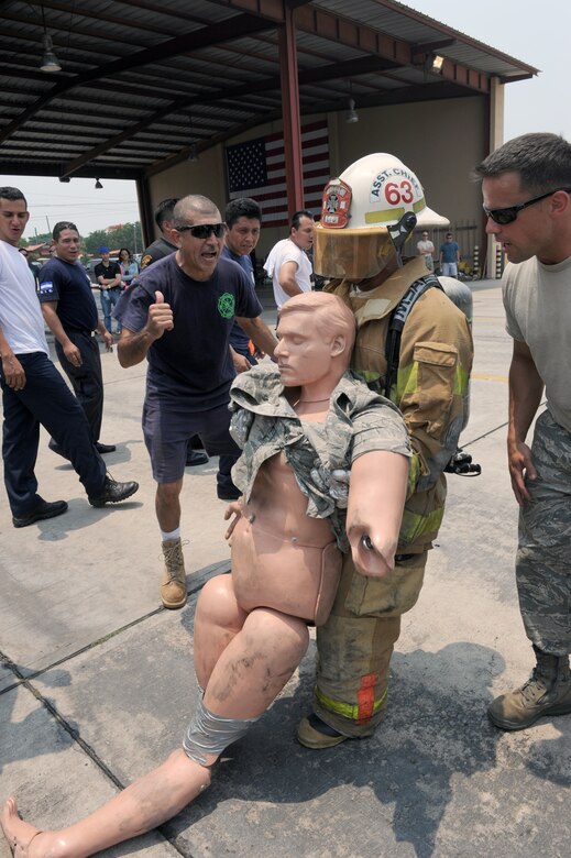 A firefighter competes in a timed obstacle course, designed to simulate the physical exertion a firefighter would experience in a hour long firefighting operation during a four day Central American Sharing Mutual Operational Knowledge and Experiences exercise, May 6-9. The four-day training exercise CENTAM SMOKE involved firefighters from Guatemala, Panama, Honduras, Nicaragua and El Salvador, allowed the firefighters a chance to train together and help build the partnerships with Joint Task Force-Bravo and the Central American countries. (DoD photo by Martin Chahin)