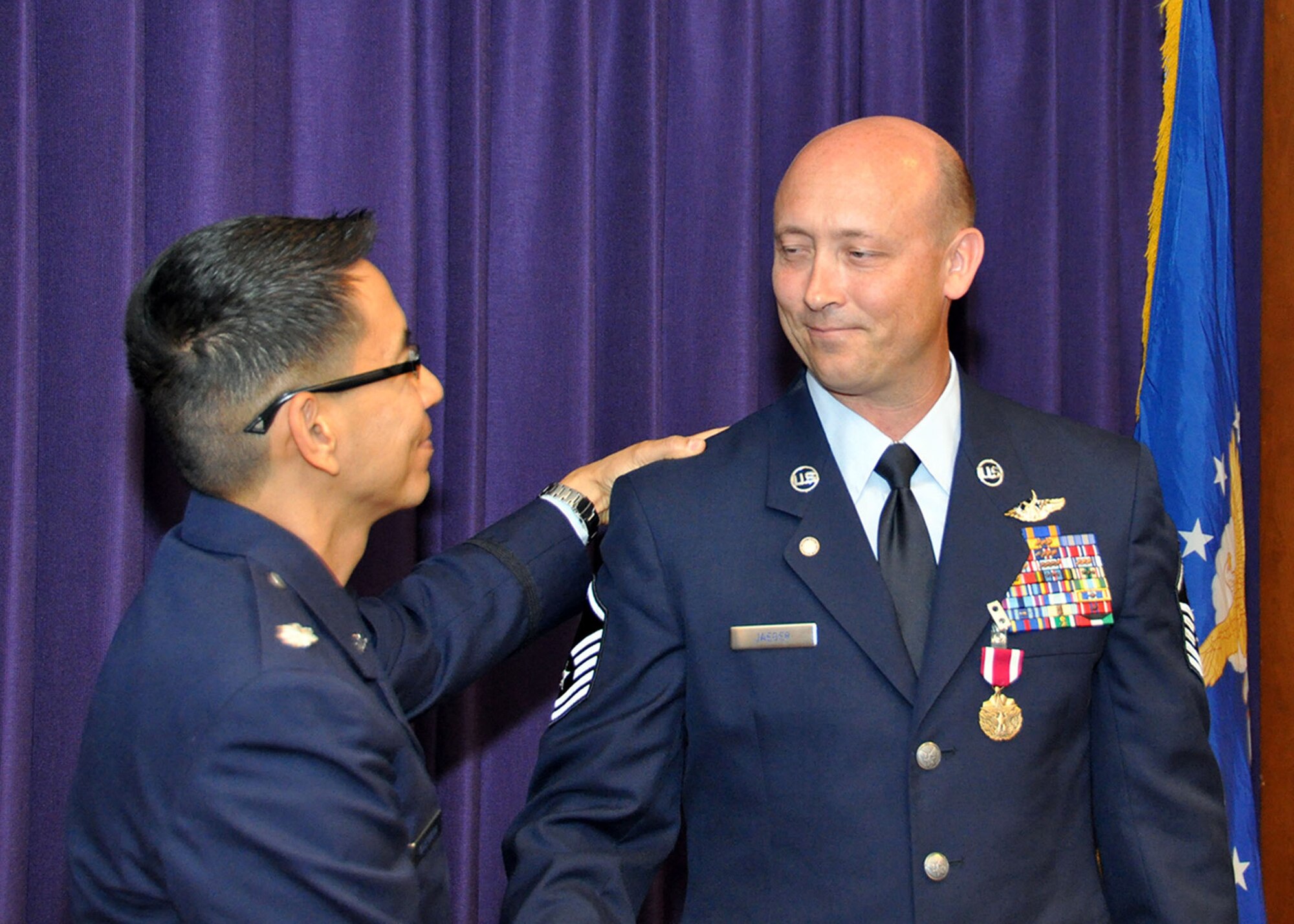 TRAVIS AIR FORCE BASE, Calif. -- Lt. Col. Gerard Guevara, 349th AMOS director of operations, congratulates Master Sgt Kevin Jaeger upon his retirement from the Air Force Reserves on his last day here. Jaeger served 29 years with the Air Force. (U.S. Air Force photo / Senior Master Sgt. Robert Wade) 
