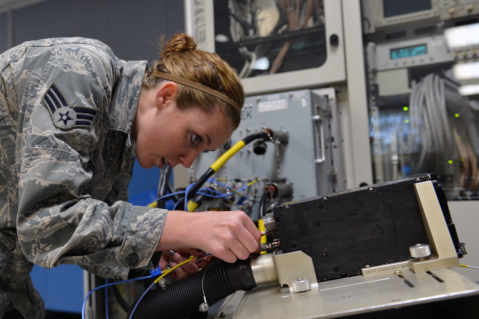Senior Airman Reagan Griffith, 62nd Maintenance Squadron avionics technician, hooks up a data entry keyboard to a C-17 Globemaster III automatic test equipment May 6, 2013 at Joint Base Lewis-McChord, Wash. The C-17 automatic test equipment detects and fixes software problems with avionics equipment. (U.S. Air Force photo/Airman 1st Class Jacob Jimenez)