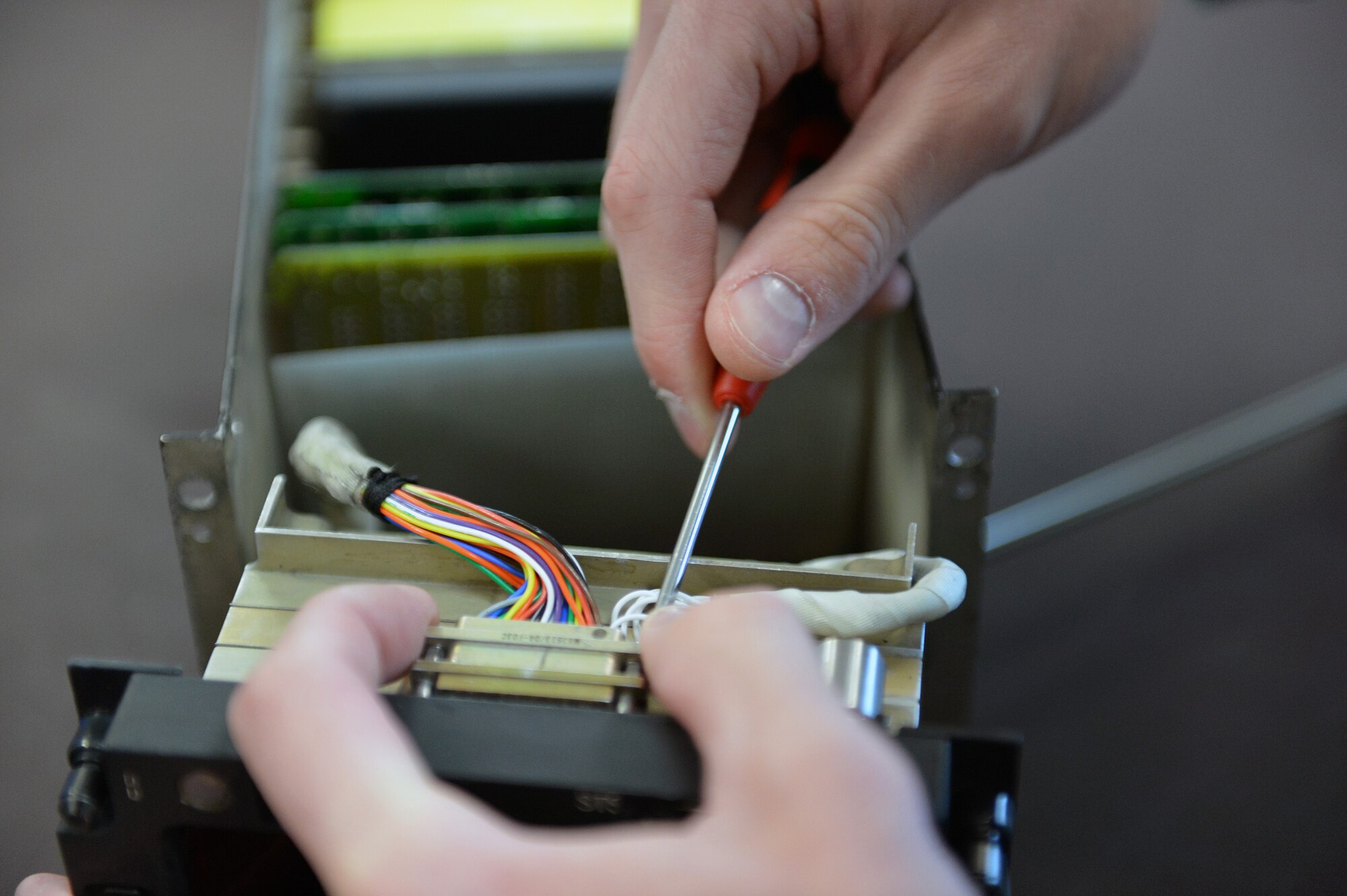 Staff Sgt. Eric Scott, 62nd Maintenance Squadron avionics technician, connects wiring to back of a mission computer digital display after replacing it May 6, 2013 at Joint Base Lewis-McChord, Wash. Mission computers control primary navigation system modes and sensors in the C-17 Globemaster III aircraft. (U.S. Air Force photo/Airman 1st Class Jacob Jimenez)   