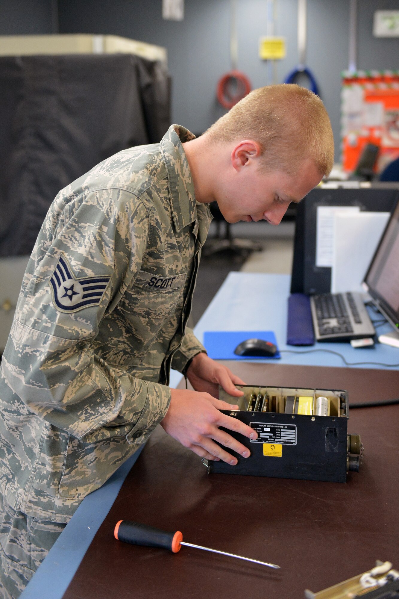 Staff Sgt. Eric Scott, 62nd Maintenance Squadron avionics technician, inserts a circuit card into a mission computer after changing out a faulty digital display May 6, 2013 at Joint Base Lewis-McChord, Wash. Mission computers are used for the display of communications, mission status and station keeping equipment information of the C-17 Globemaster III aircraft. (U. S. Air Force photo/Airman 1st Class Jacob Jimenez)      