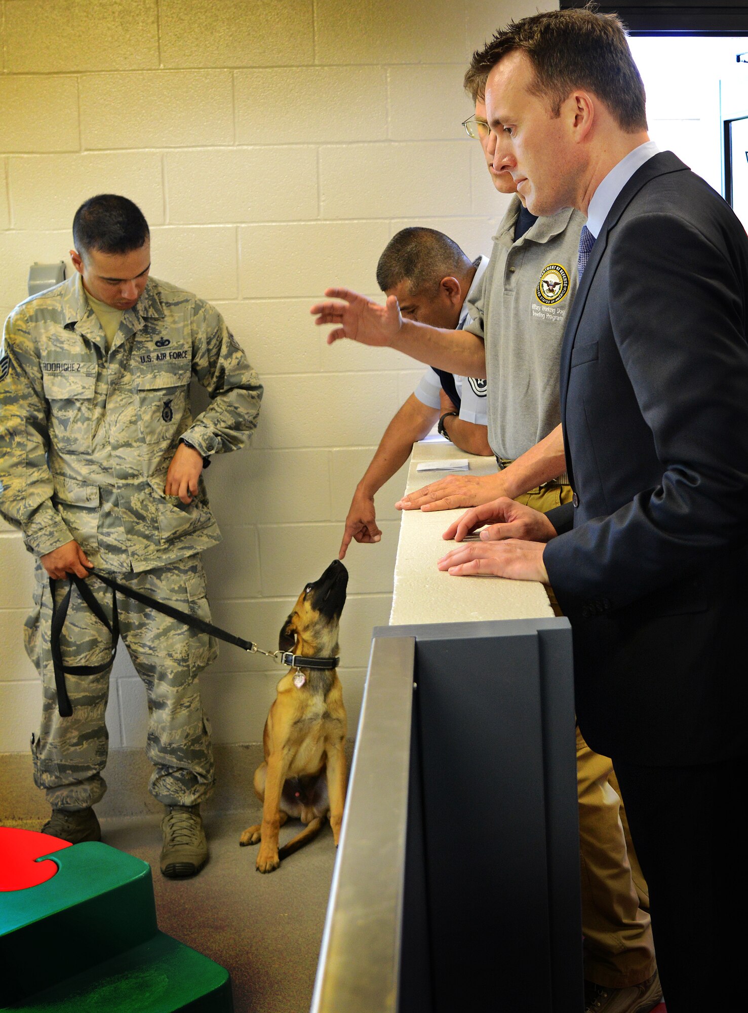 Under secretary of the Air Force Eric Fanning tours the military working dog facility May 17, 2013, at Joint Base San Antonio-Lackland, Texas. The facility staff members provide trained military working dogs used in patrols, drug and explosive detection, and specialized mission functions for the Department of Defense and other government agencies. Fanning visited with members of Joint Base San Antonio May 16 and 17 with stops at Randolph, Lackland and Fort Sam Houston as part of his first base visit as under secretary. (U.S. Air Force photo/Benjamin Faske) 