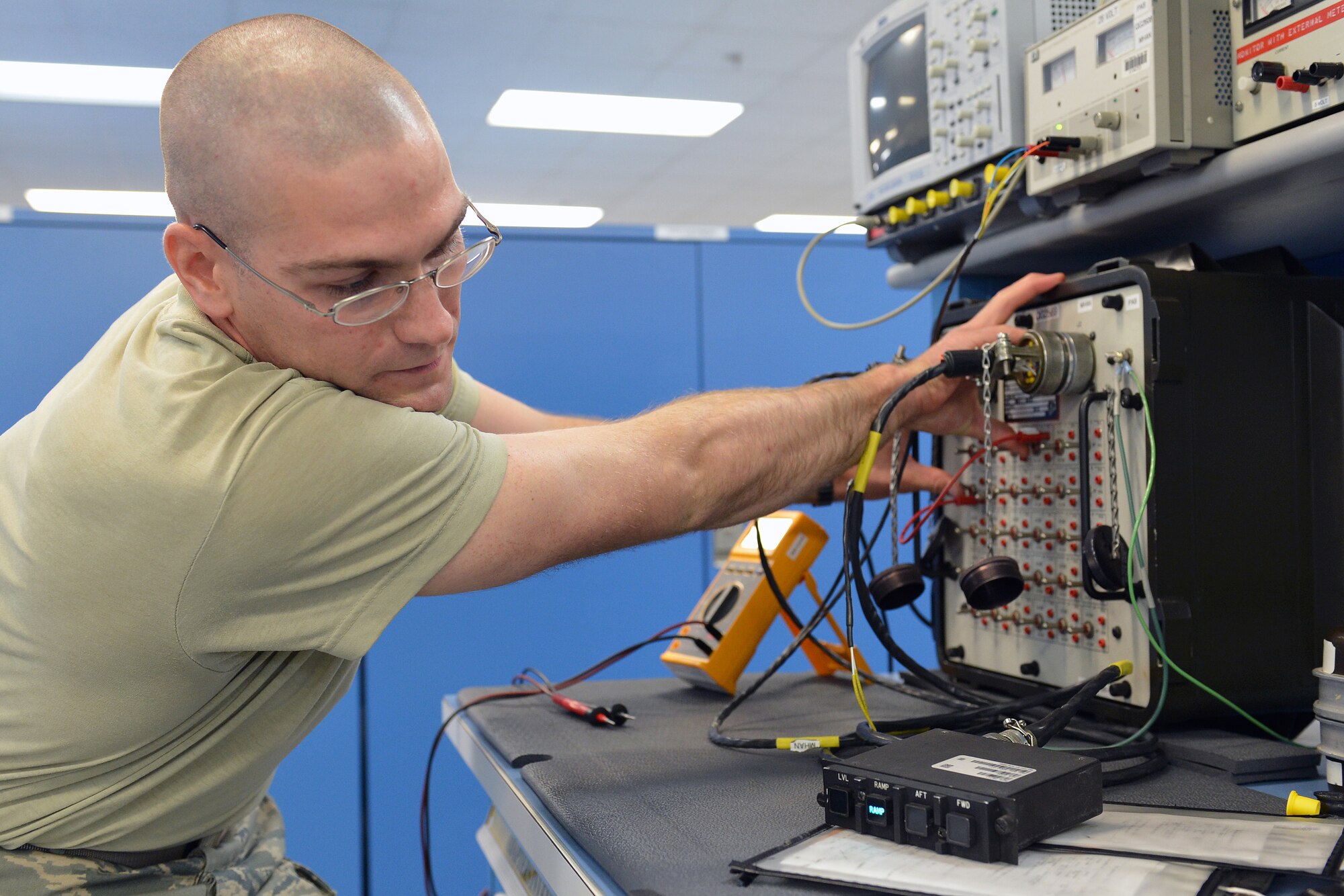 Senior Airman Curtis Rosga, 62nd Maintenance Squadron avionics technician, troubleshoots a public address control using a breakout and an oscilloscope May 13, 2013 at Joint Base Lewis-McChord, Wash. After testing the voltage on the public address control, Rosga was able to identify the problem as broken light bulbs. (U.S. Air Force photo/Airman 1st Class Jacob Jimenez)   