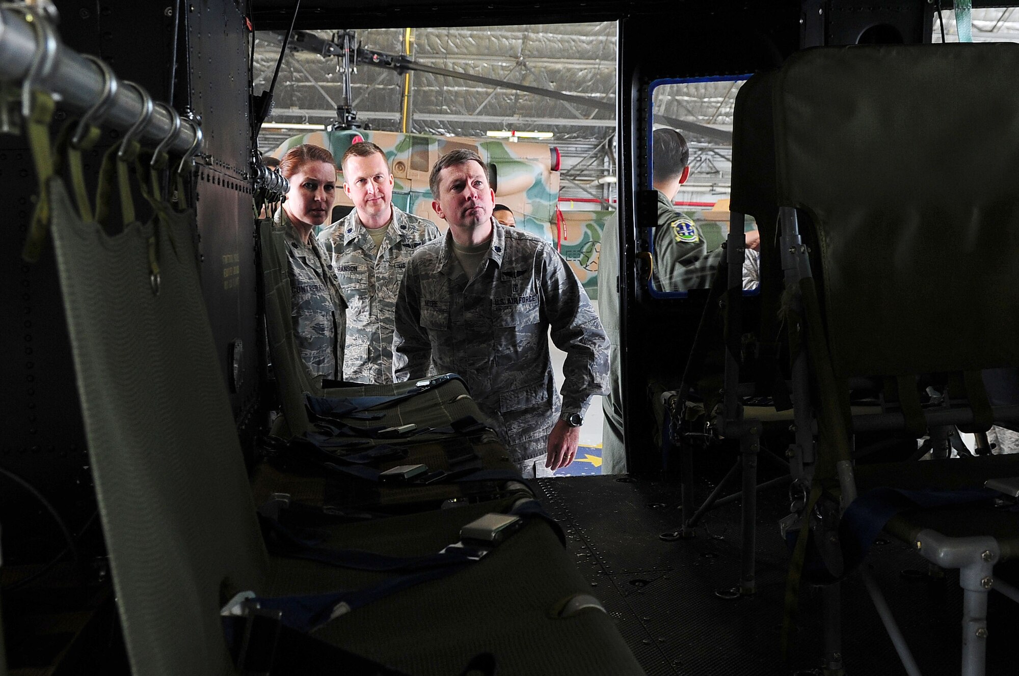 Incoming commanders to Joint Base Andrews look inside a UH-1N Huey Helicopter during a tour of the 1st Helicopter Squadron as part of the Air Force District of Washington Commanders Course May 15, 2013, at JBA, Md. The 1HS has maintained support within the National Capital Region and on JBA since the 1970s. (U.S. Air Force photo by Senior Airman Steele C. G. Britton)