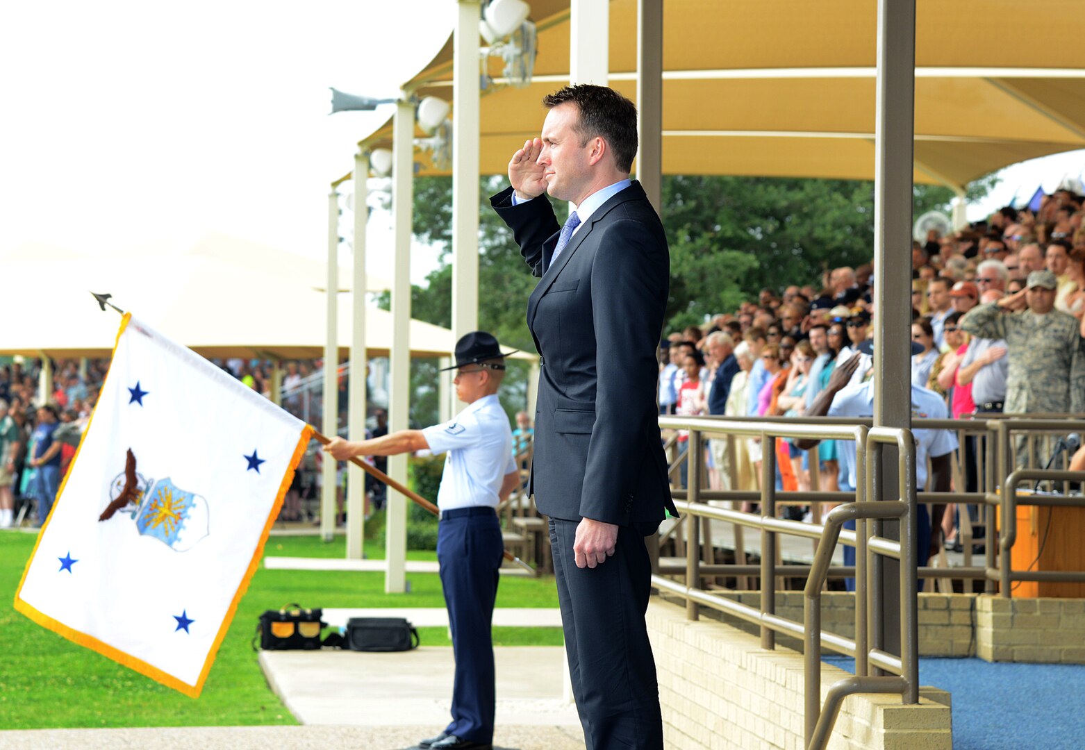 Under secretary of the Air Force Eric Fanning salutes during the playing of the National Anthem at an Air Force Basic Military Training graduation May 17, 2013, at Joint Base San Antonio-Lackland. Fanning visited with members of Joint Base San Antonio May 16 and 17 with stops at Randolph, Lackland, and Fort Sam Houston as part of his first base visit as under secretary. (U.S. Air Force photo/Benjamin Faske) 