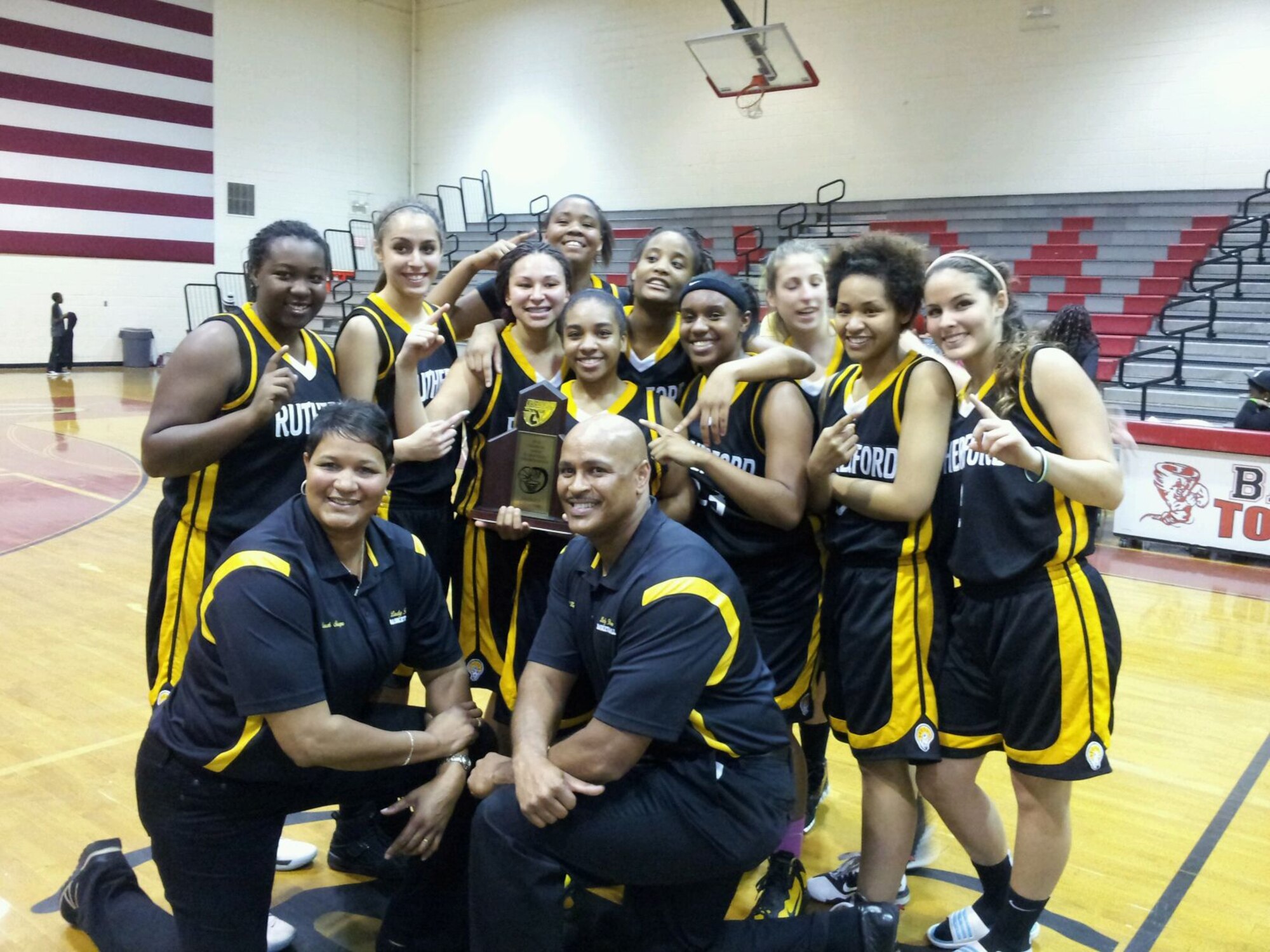 The Rutherford High School girl's basketball team celebrates winning the dirstrict championship with their coach Allen Kelly, 325th Fighter Wing Continental U.S. North American Aerospace Defense Command Region - 1st Air Force (Air Forces Northern)/Tyndall command center chief. Mr. Kelly was named Coach of the Year by the Florida Athletic Coaches Association. (Courtesy photo)