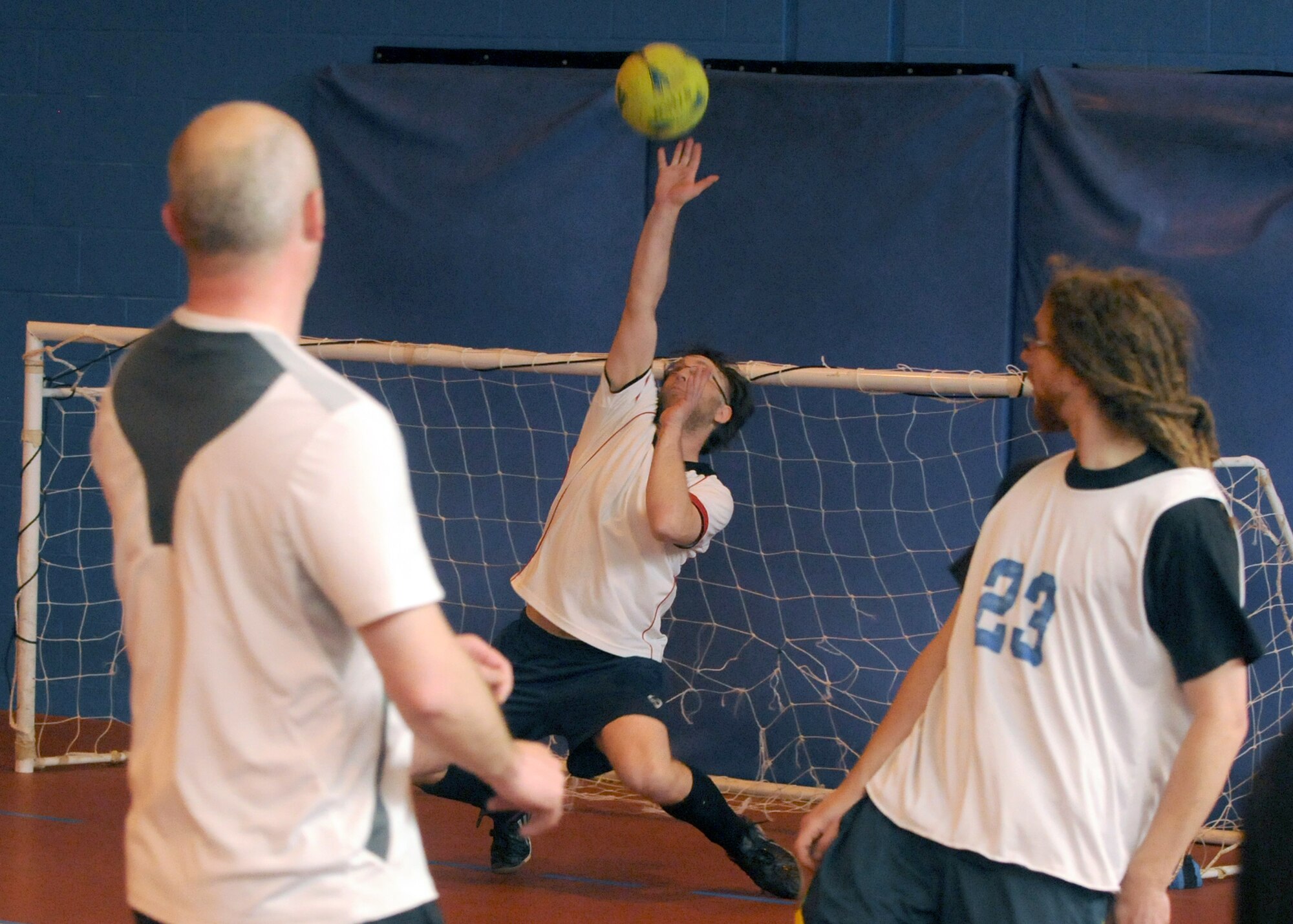Barry King, goalkeeper for the 100th Civil Engineer Squadron team, stops a shot at goal from members of the 100th Maintenance Group team during an extramural soccer championship game May 23, 2013, at RAF Mildenhall, England. CES beat MXG five to one to retain their title. (U.S. Air Force photo by Tech. Sgt. Neal X. Joiner/Released)