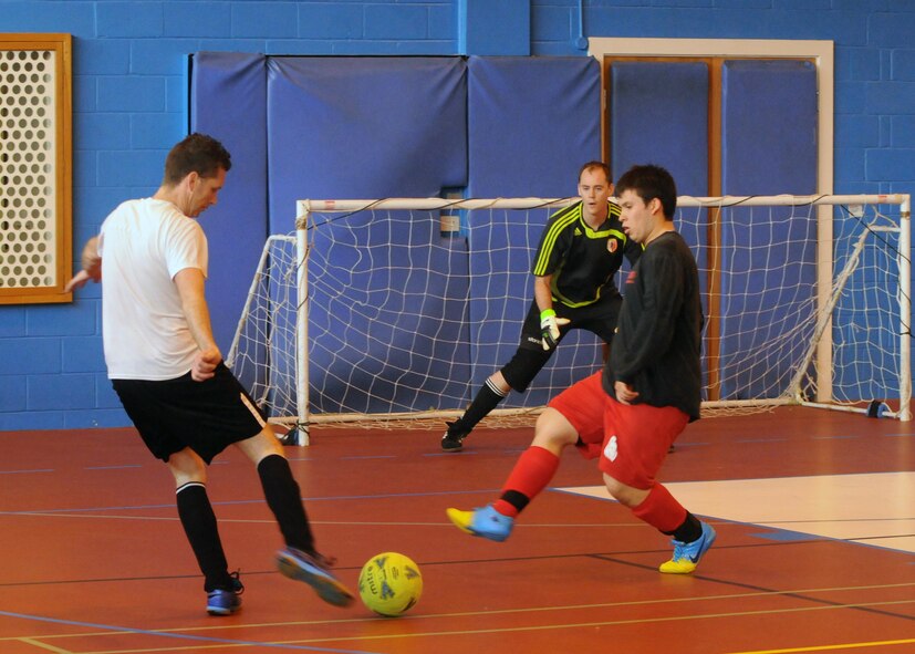 Andrew Keogh, left, from the 100th Civil Engineer Squadron team, attempts a goal as Michael Garcia, right, a dependant with the 100th Maintenance Group team, defends during the extramural soccer championship game May 23, 2013, at RAF Mildenhall, England. The 100th CES beat the 100th MXG five to one to. (U.S. Air Force photo by Tech. Sgt. Neal X. Joiner/Released)
