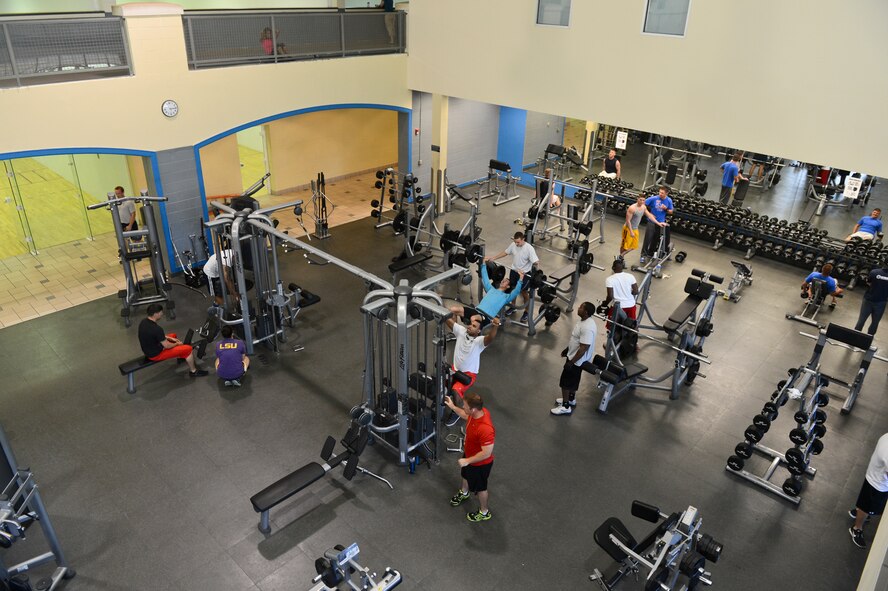 Patrons of the Senior Airman Bryan Bell Fitness Center exercise in the weight room on Barksdale Air Force Base, La., May 22, 2013. The fitness center is open from 4 a.m. to midnight on weekdays and 8 a.m. to 6 p.m. on weekends. (U.S. Air Force photo/Senior Airman Micaiah Anthony)
