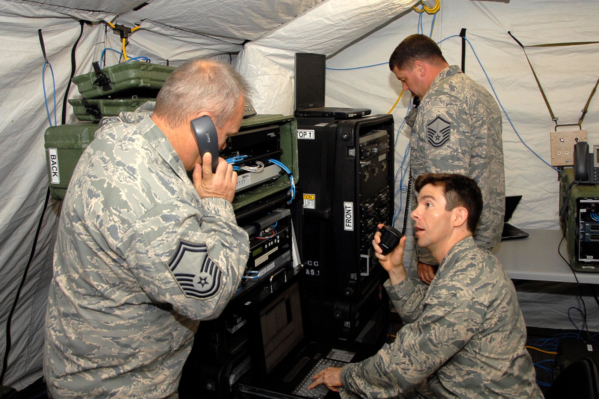 U.S. Air Force Senior Master Sgt. Greg Stevens, 1st Lt. Michael Wingrave, and Master Sgt. Chad Valentine work in the Joint Incident Site Communications Capability (JISCC) during the Ardent Sentry exercise in West Columbia May 19, 2013. The S.C. National Guard is participating in a major NORAD and USNORTHCOM sponsored training exercise called Ardent Sentry, May 17-21, 2013.  It involves a scenario of a hurricane striking the South Carolina coast, requiring more than 1,500 members of the S.C. National Guard to practice disaster response activities and coordination procedures.  (U.S. Air National Guard photo by Lt. Col. Jim St. Clair/Released)