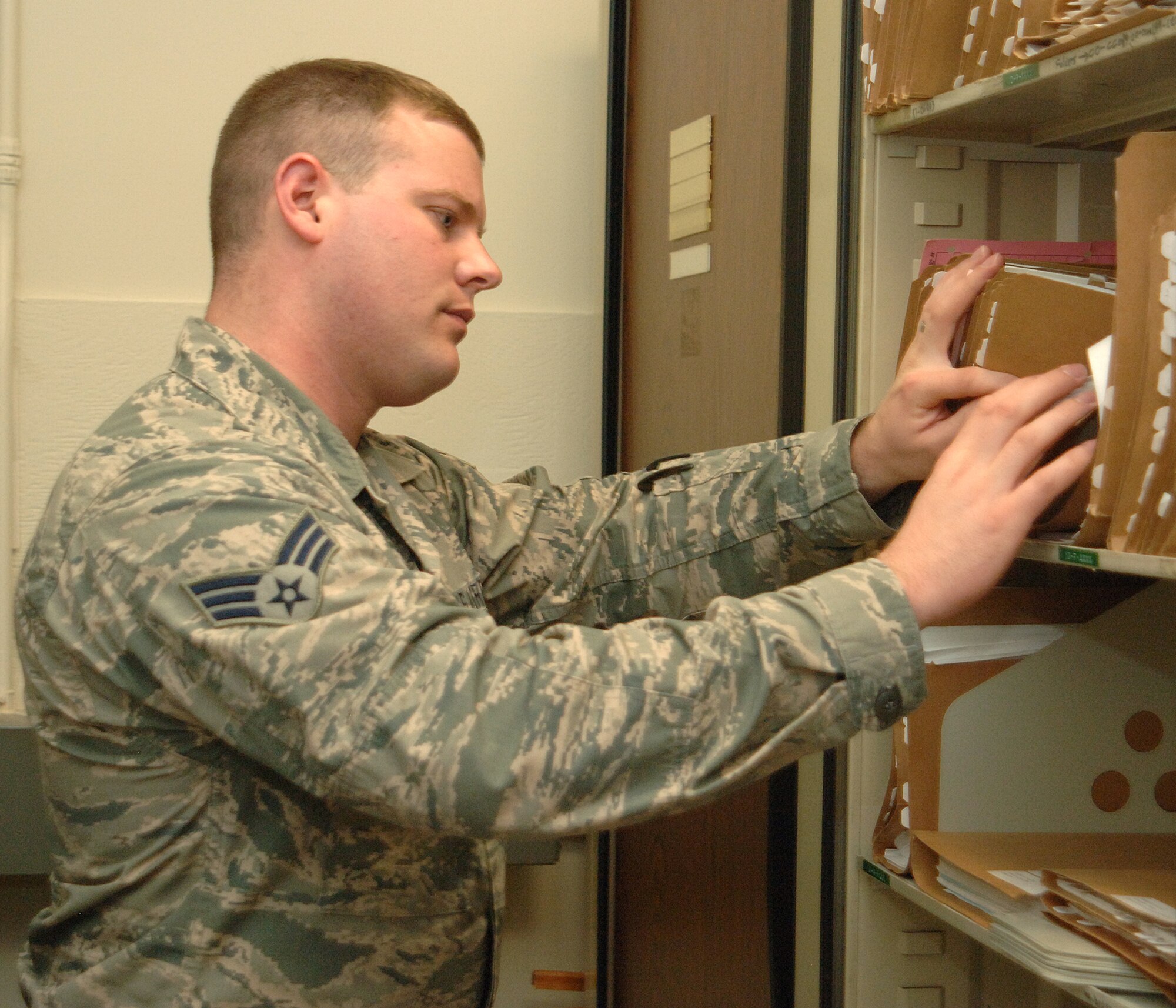 Senior Airman Ernest Trosen, 319th Contracting Flight contract administrator, organizes files for the contracting flight on May 16, 2013, on Grand Forks Air Force Base, N.D. The Walcott, N.D., native was named the base’s Warrior of the Week for the fourth week of May 2013. (U.S. Air Force photo/Airman 1st Class Zachiah Roberson)
