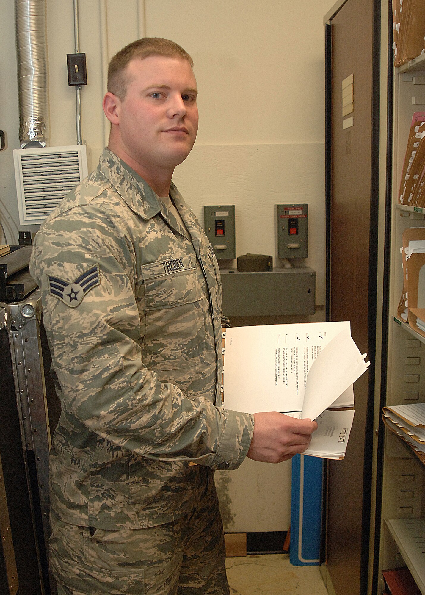 Senior Airman Ernest Trosen, 319th Contracting Flight contract administrator, organizes files for the contracting flight on May 16, 2013, on Grand Forks Air Force Base, N.D. The Walcott, N.D., native was named the base’s Warrior of the Week for the fourth week of May 2013. (U.S. Air Force photo/Airman 1st Class Zachiah Roberson)