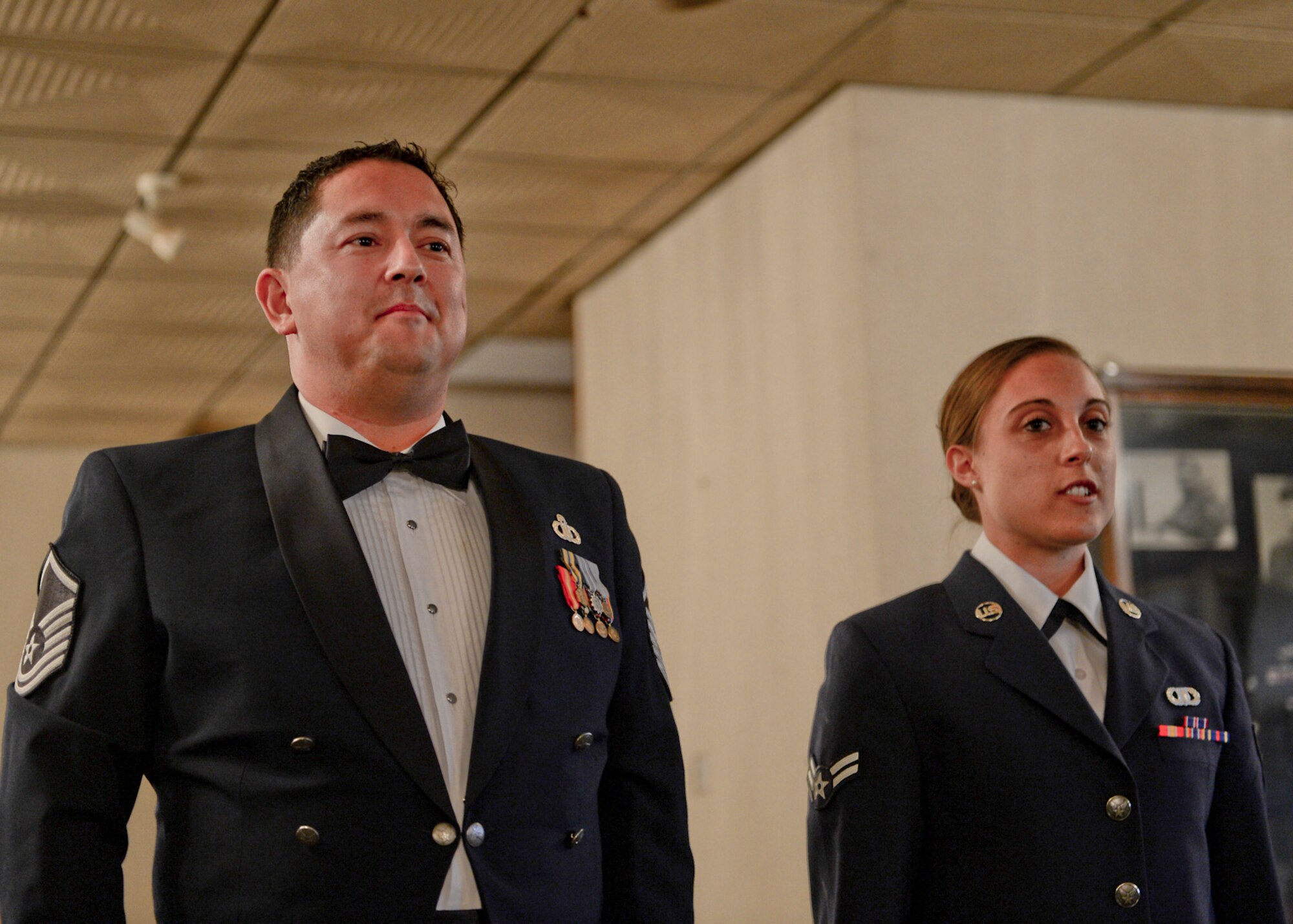 ROYAL AIR FORCE LAKENHEATH, England—Master Sgt. Robert Liggon (left), 48th Operations Support Squadron radar approach control chief controller, and Airman 1st Class Sarah Harnitchek, 48th Operation Support Squadron radar approach control journyman, reports to center stage during air traffic control dining-out May 18, 2013. The practice of dining-out began in the 18th century by British military and was adopted by the U.S. military. (U.S. Air Force photo by Staff Sgt. Stephanie Mancha) 