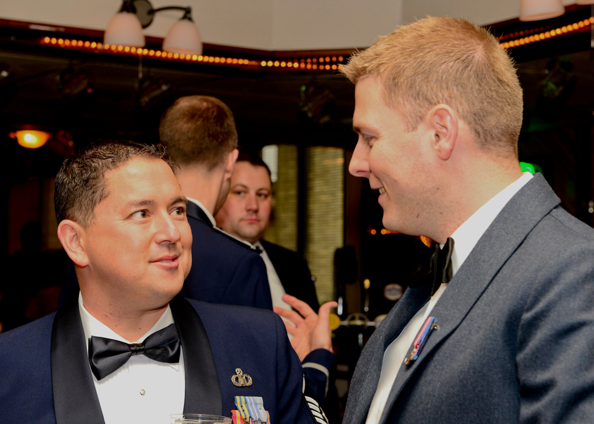 ROYAL AIR FORCE LAKENHEATH, England -- Master Sgt. Robert Liggon (left), 48th Operations Support Squadron radar approach control chief controller, and British Royal Air Force Sergeant Dan Lee air traffic controller from RAF Marham socialize during the air traffic control dining-out May 18, 2013. The practice of the dining-out began in the 18th century by British military and was adopted by the U.S. military. (U.S. Air Force photo by Staff Sgt. Stephanie Mancha) 
