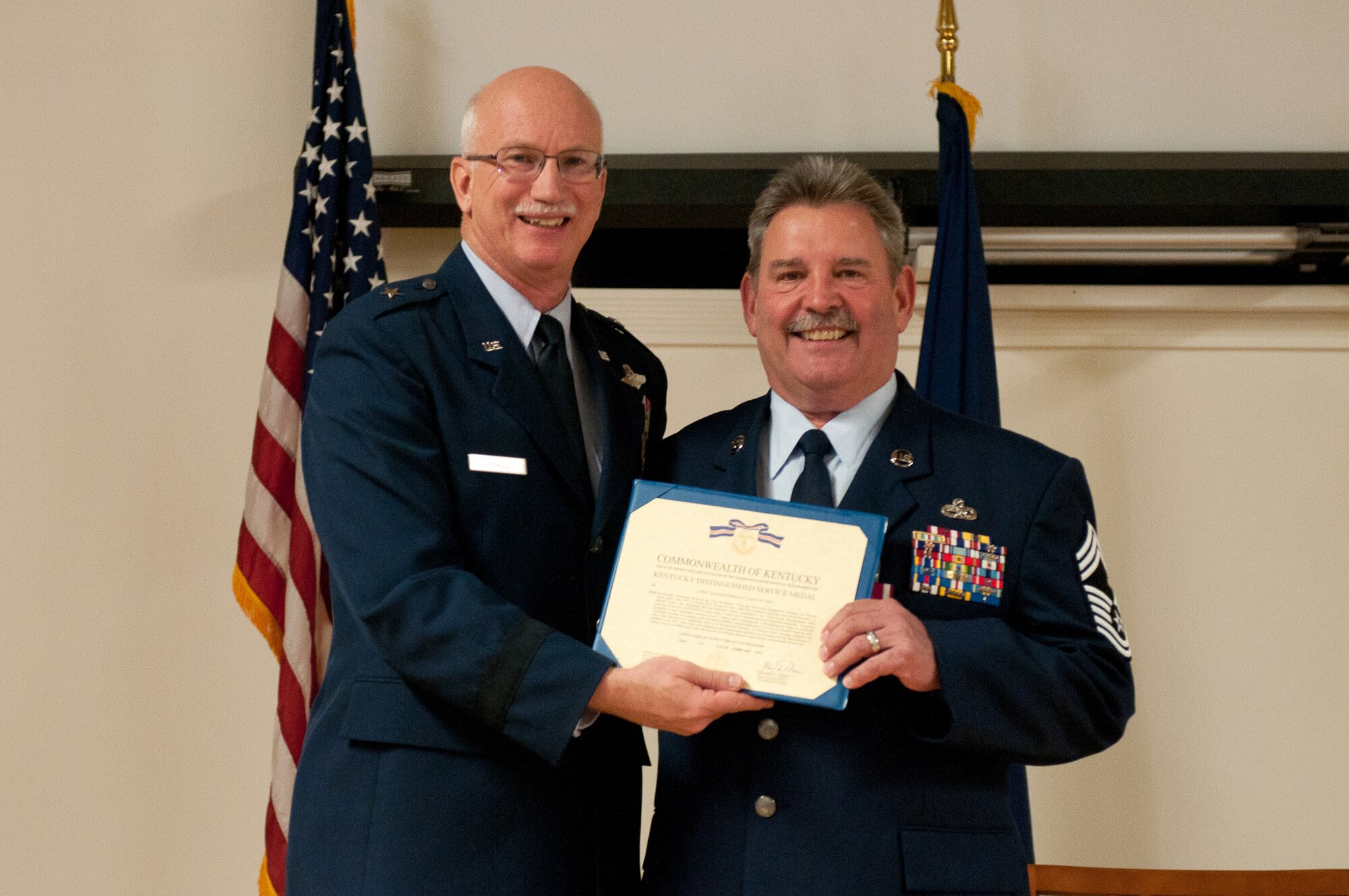 Chief Master Sgt. David Fink (right) is presented with a Kentucky Distinguished Service Medal by Brig. Gen. Mark Kraus, Kentucky’s assistant adjutant general for Air, during a retirement ceremony held in Fink’s honor at the Kentucky Air National Guard Base in Louisville, Ky., on March 17, 2013. Fink, the chief enlisted manager for force support at Joint Forces Headquarters—Kentucky, served in the active-duty Air Force and Air National Guard for 42 years. (U.S. Air National Guard photo by Airman Joshua Horton)