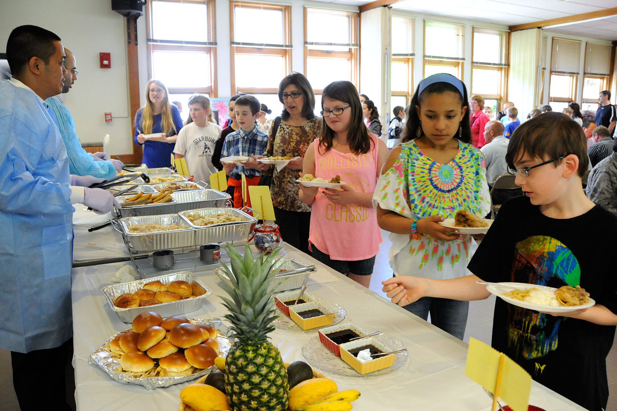 HANSCOM AIR FORCE BASE, Mass. -- Hanscom Middle School students enjoy a variety of multi-cultural food dishes during an Asian Pacific American food tasting lunch event that was held at the Chapel Annex May 16. In addition to lunch, the event included a martial arts demonstration and a presentation by Susumu Ito on his experiences as a Japanese American officer. (U.S. Air Force photo by Linda LaBonte Britt)