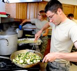 2nd Lt. Dan Venable, the air operations flight officer for the 71st Operations Support Squadron, heats up some vegetables for a stir fry during the Singles’ International Gourmet Meal Opportunity held May 20 in the Community Chapel Activity Center at Vance Air Force Base, Okla. (U.S. Air Force photo/ Senior Airman Frank Casciotta)