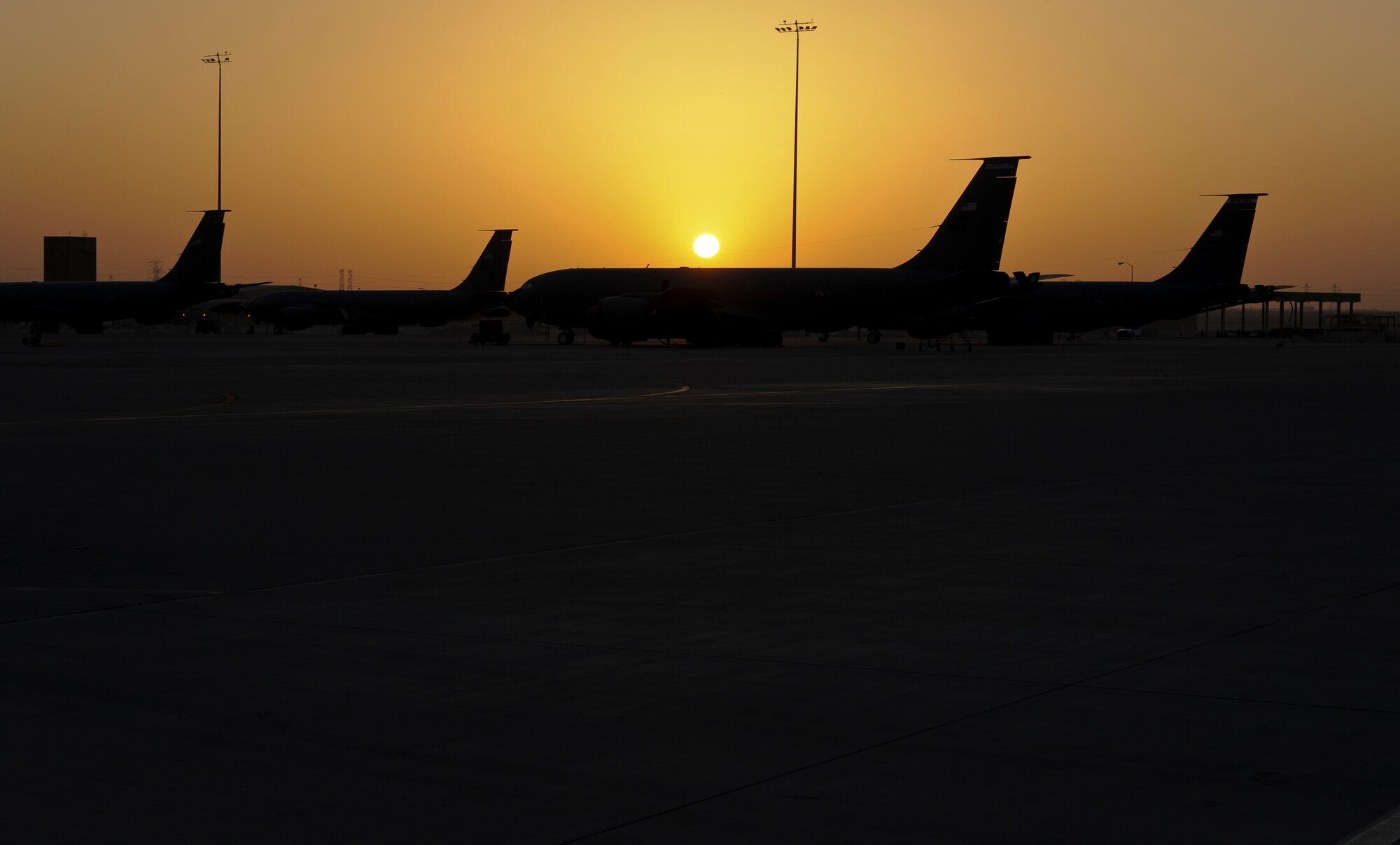 As the sunrises, KC-135 Stratotankers assigned to the 379th Air Expeditionary Wing, await their next mission within the area of operations May 18, 2013, in Southwest Asia. (U.S. Air Force photo/Senior Airman Benjamin Stratton)