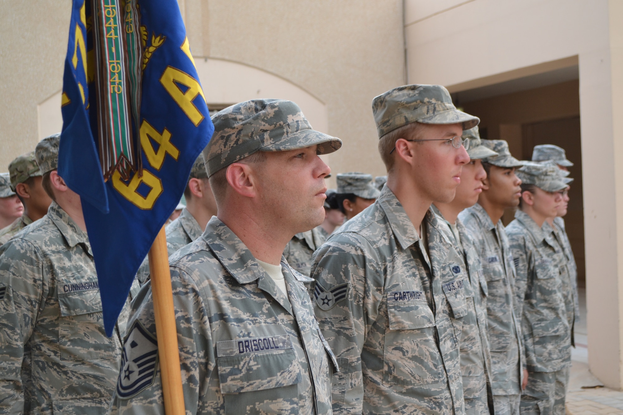 Master Sgt. Joseph Driscoll stands in formation with members of his squadron during the retreat ceremony as part of the Police Week activities at Eskan Village in Southwest Asia, May 15, 2013. Driscoll is the 64th Expeditionary Security Forces Squadron first sergeant. (U.S. Air Force photo/Staff Sgt. Jason Colbert)